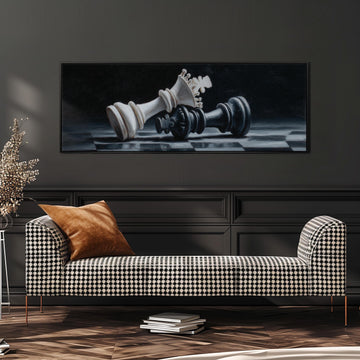 a large black and white chess set, with the king and queen pieces prominently displayed. The chess set is placed on a checkered surface, and there is a black and white checkered sofa with a brown throw pillow in the foreground.
