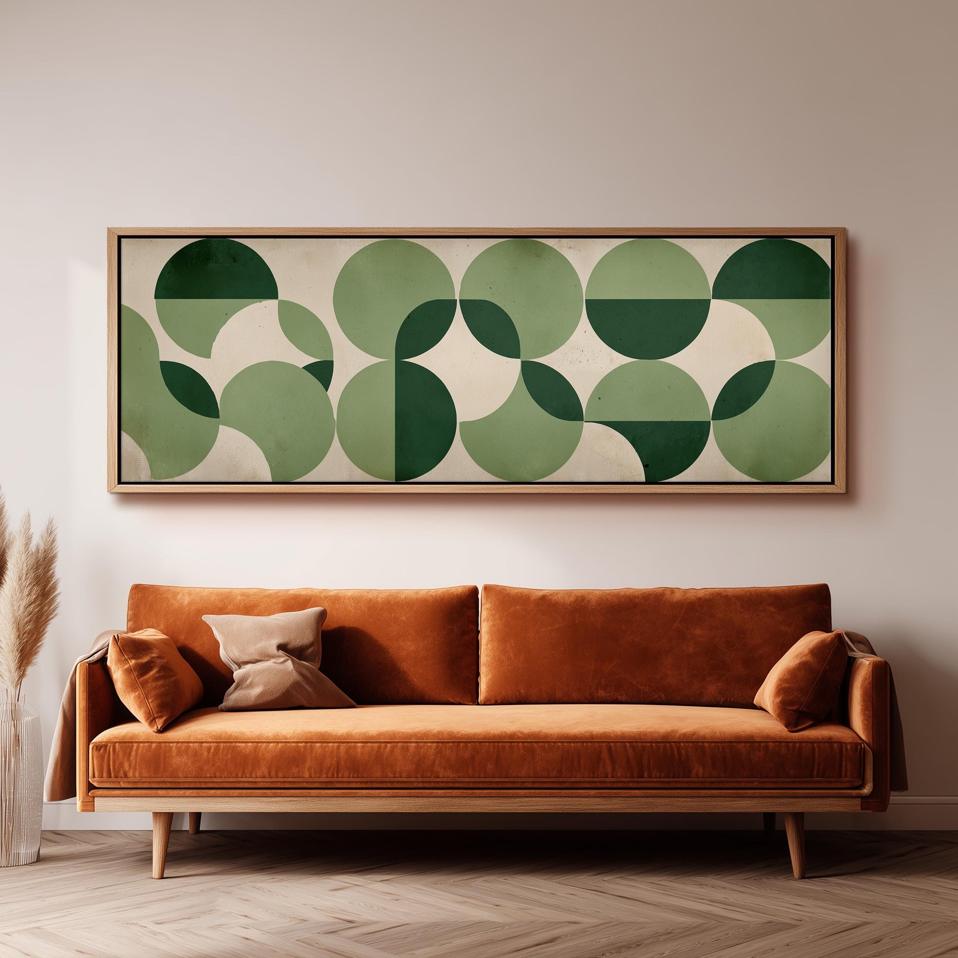 a large, rectangular abstract artwork hanging on a wall above a brown sofa with orange cushions.