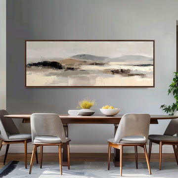 a dining room with a large painting of a landscape hanging on the wall above a wooden dining table with four chairs. The table is set with a bowl of fruit and a vase of flowers, creating a cozy and inviting atmosphere.