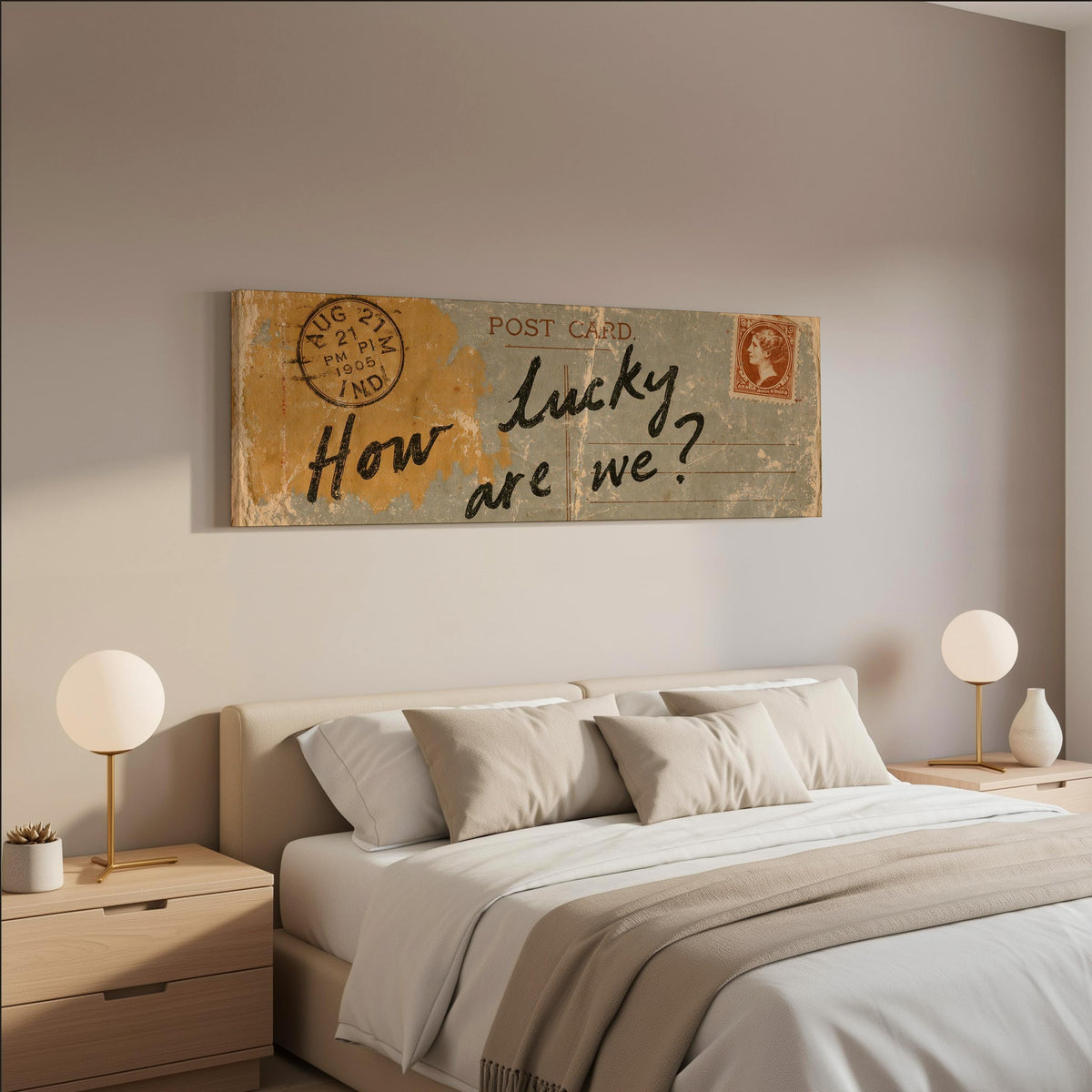 Vintage postcard saying how lucky are we wide panoramic canvas print above a bed in a neutral bedroom