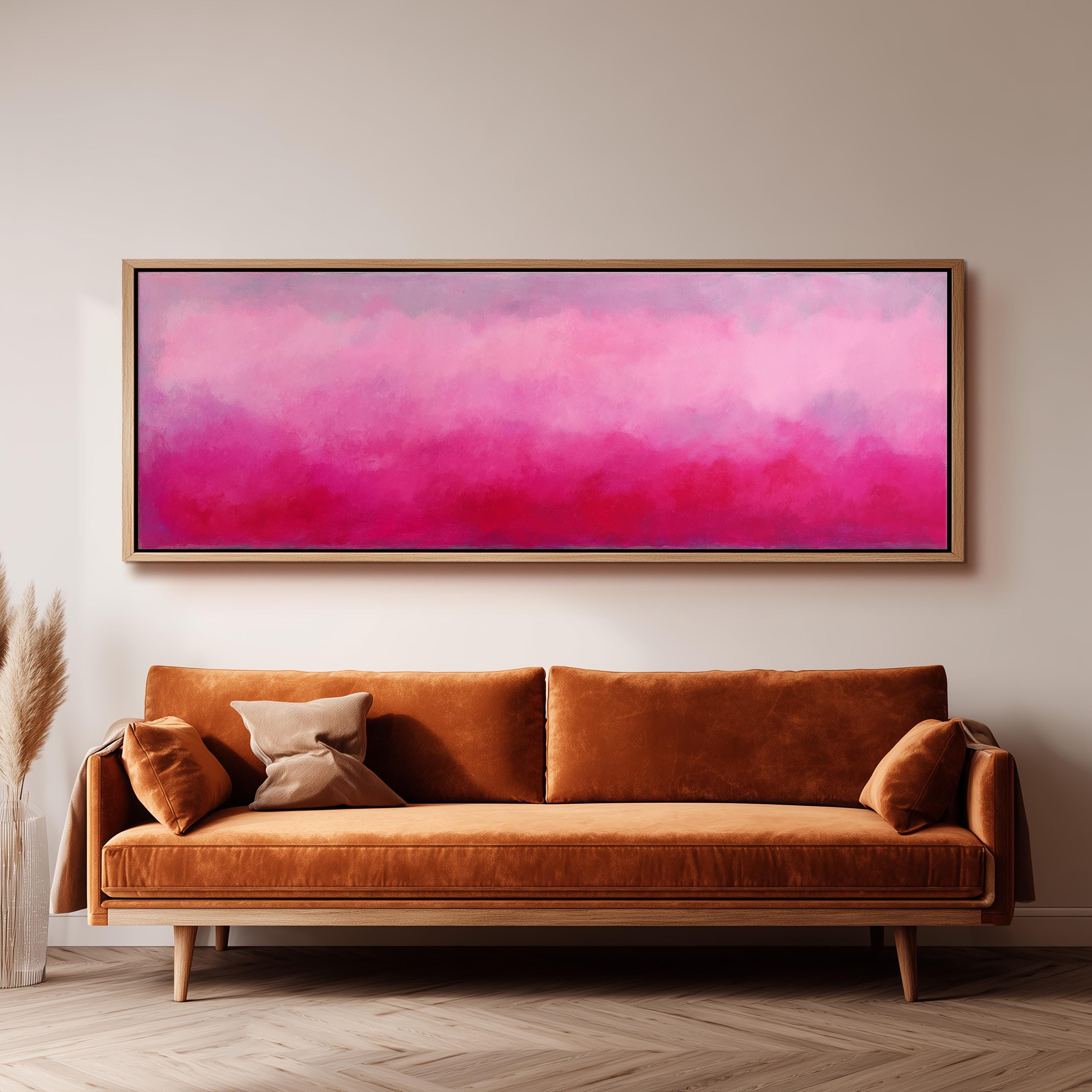 a large, rectangular painting hanging on a wall above a brown sofa with two pillows.