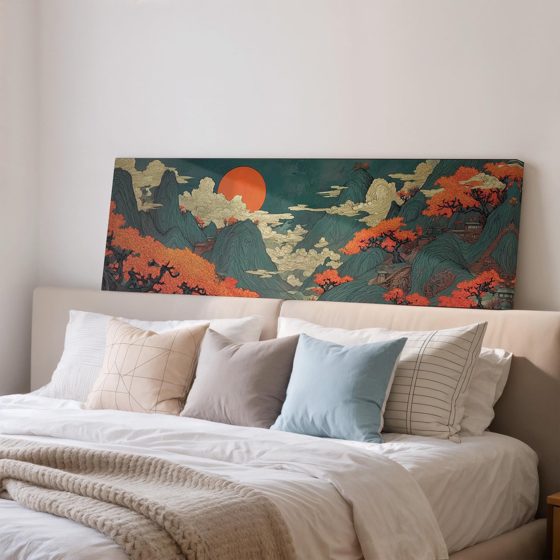 a large, colorful painting of a mountainous landscape with a prominent orange sun in the sky, hanging on a wall above a brown sofa.