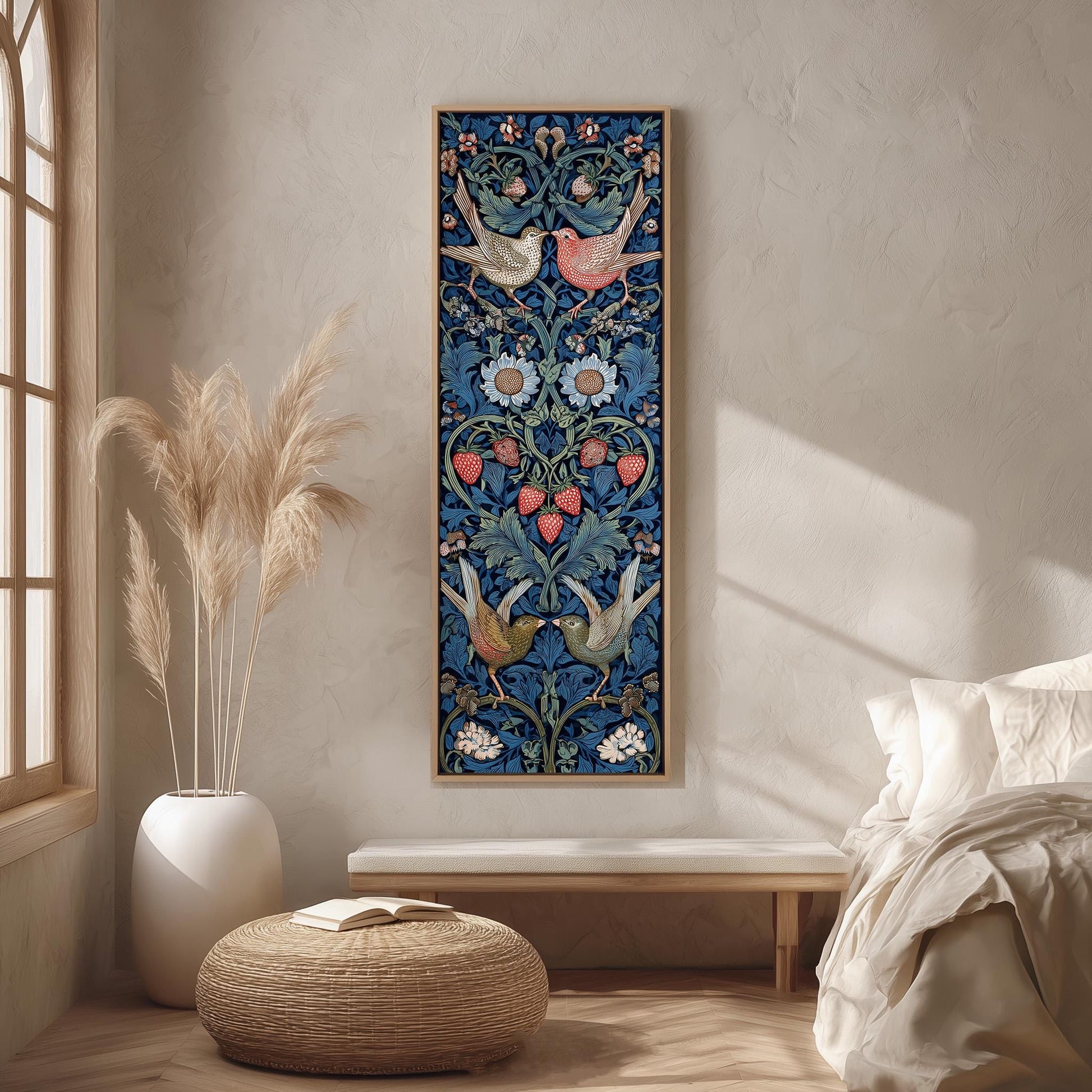 a large, colorful tapestry hanging on a wall in a bedroom. The tapestry is adorned with intricate floral and bird designs in shades of blue, red, and green. The room has a minimalist and modern aesthetic, with a white bed, a wooden bench, and a woven ottoman. The overall color scheme of the room is predominantly white and beige, with pops of color from the tapestry and the potted plant.