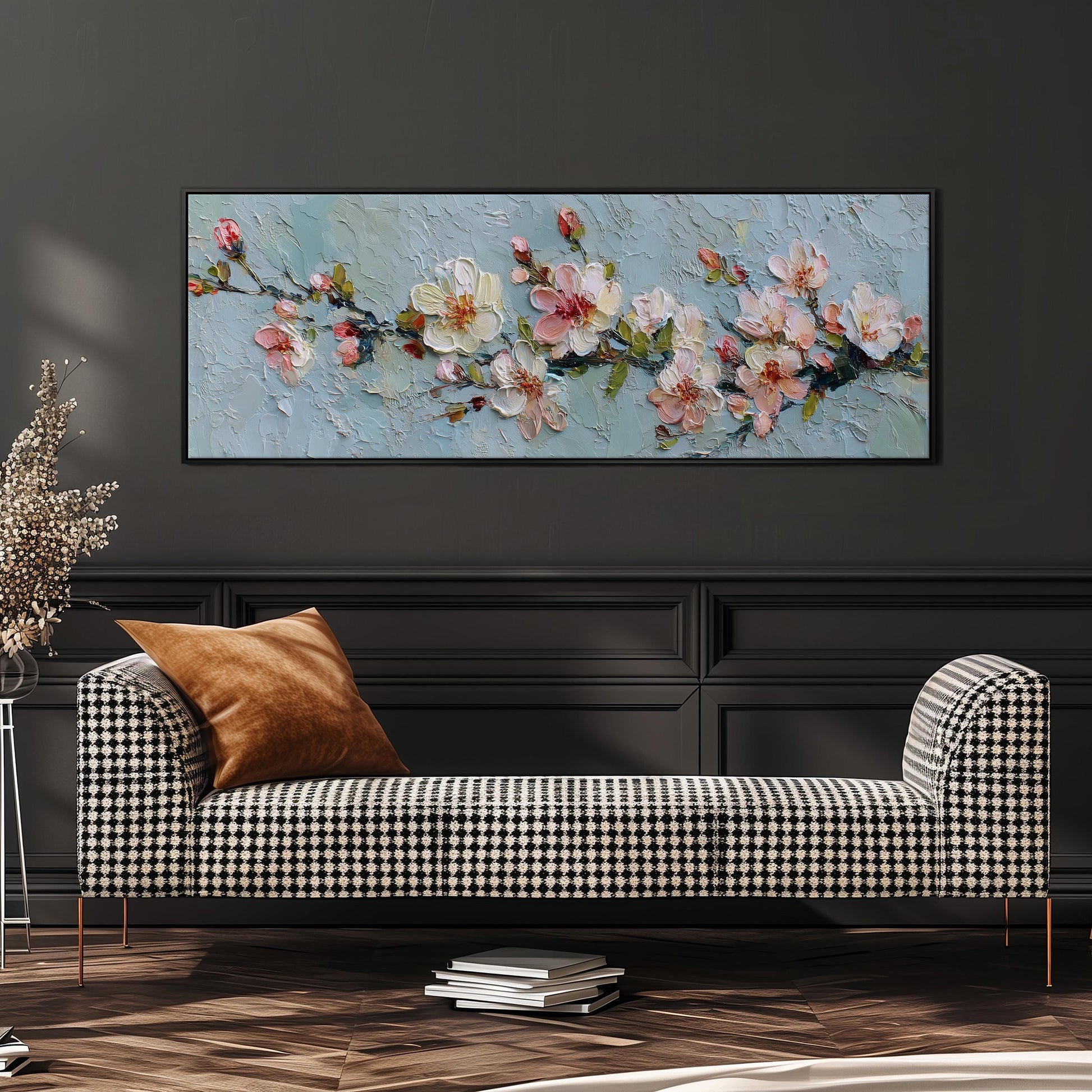 a large painting of flowers hanging on a wall above a black and white checkered sofa in a living room setting.