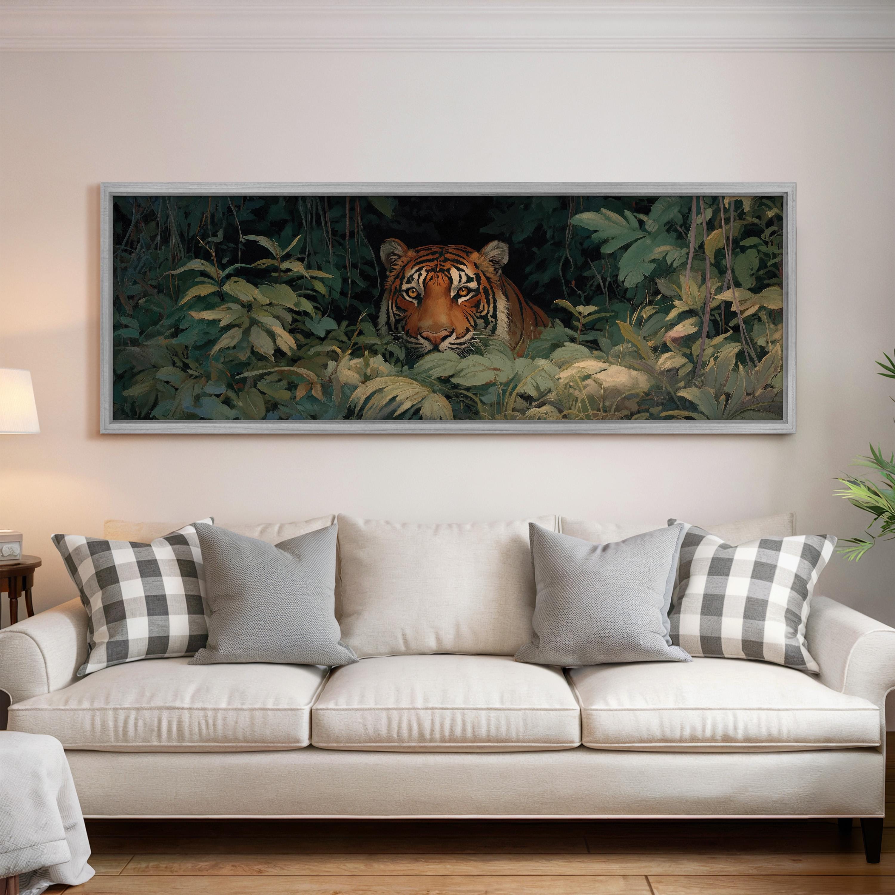a large painting of a tiger peeking out from the foliage above a white sofa with patterned throw pillows.