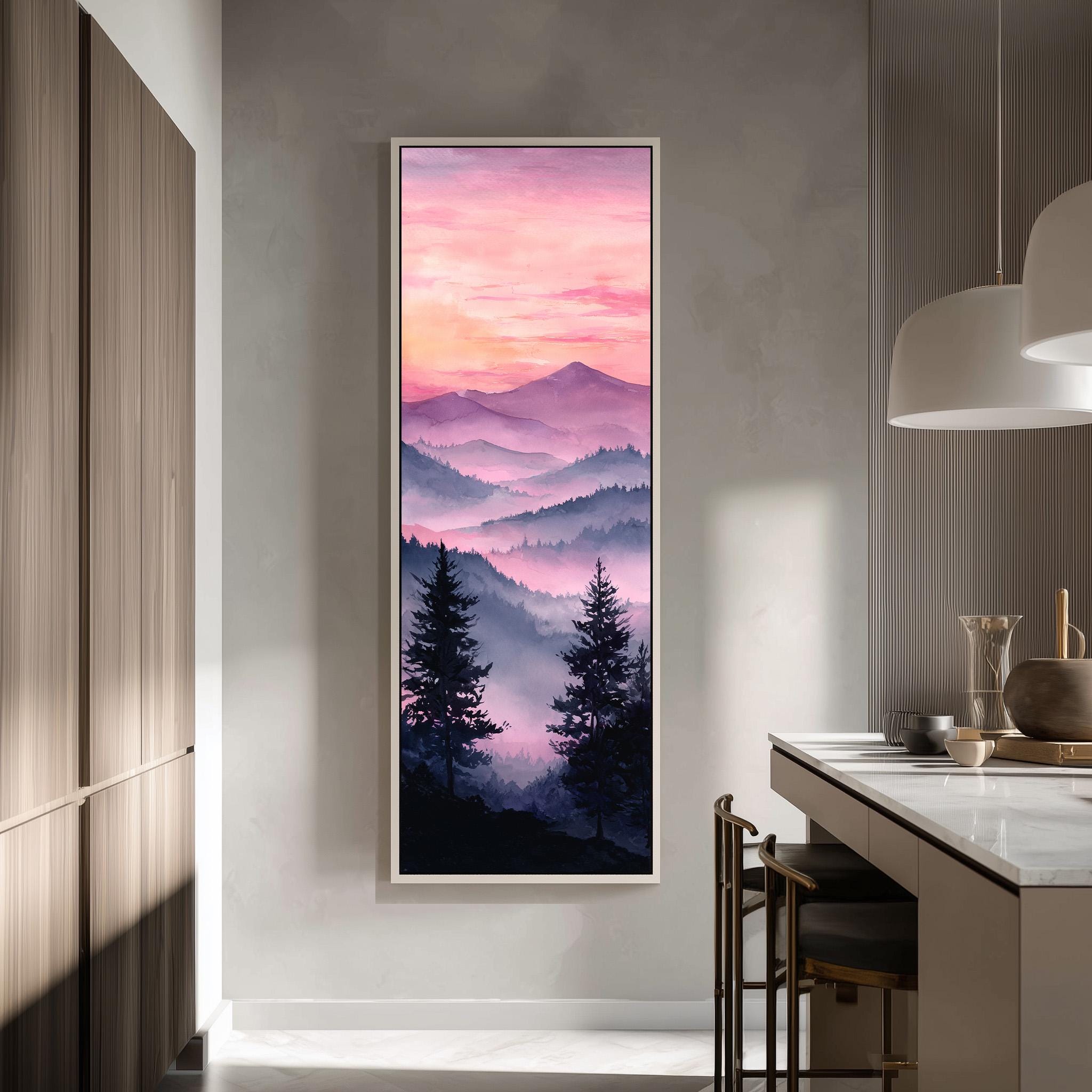 a large framed painting of a mountain landscape with a sunset sky, hanging on a wall in a modern kitchen.