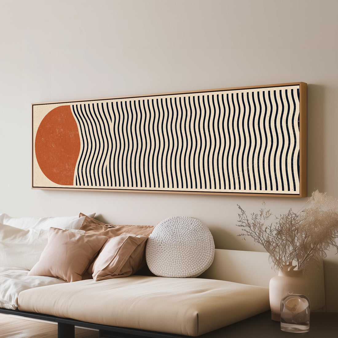 Terracotta sun with wavy black lines long horizontal canvas print above a sofa in a living room