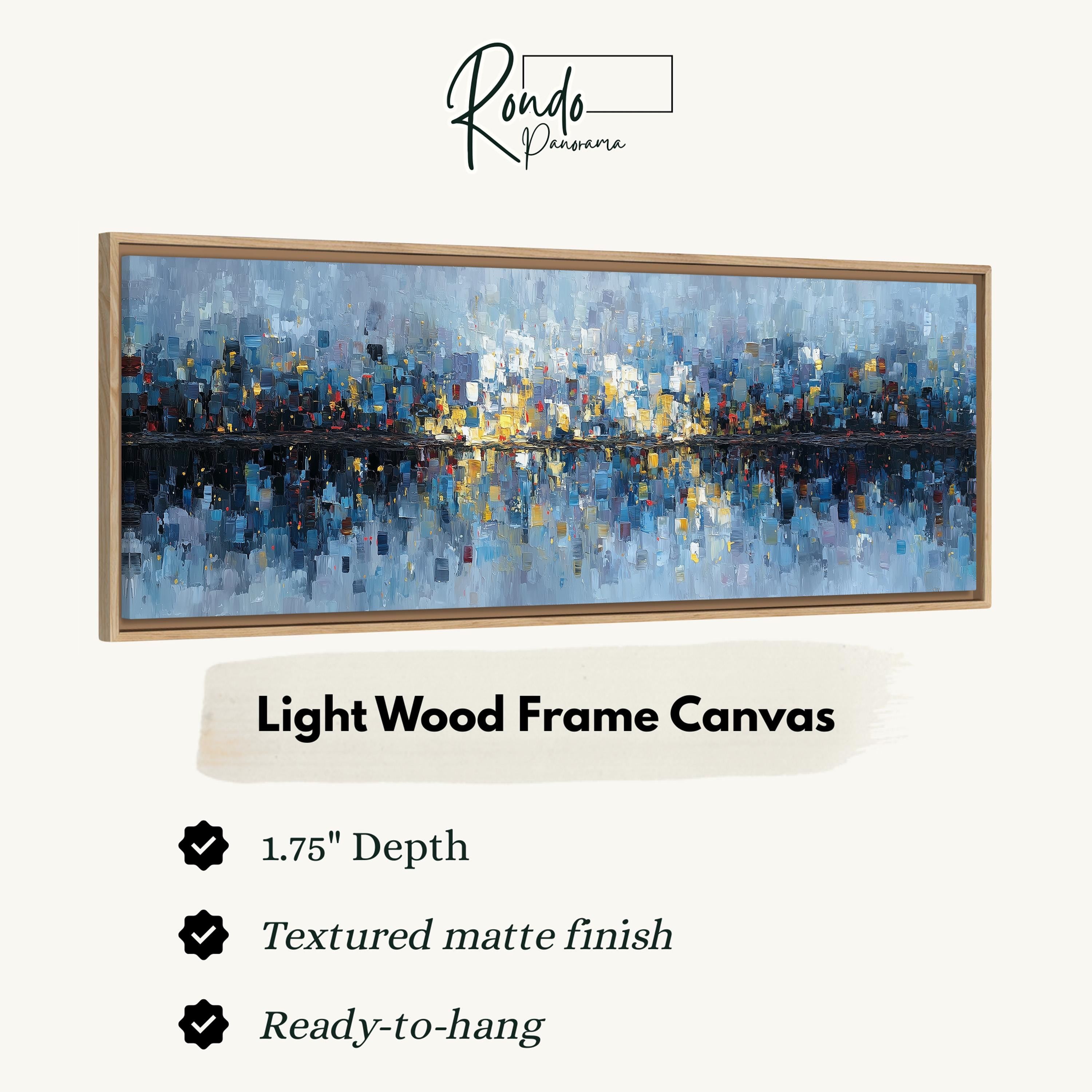 The image is a framed artwork depicting a cityscape with a light wood frame.