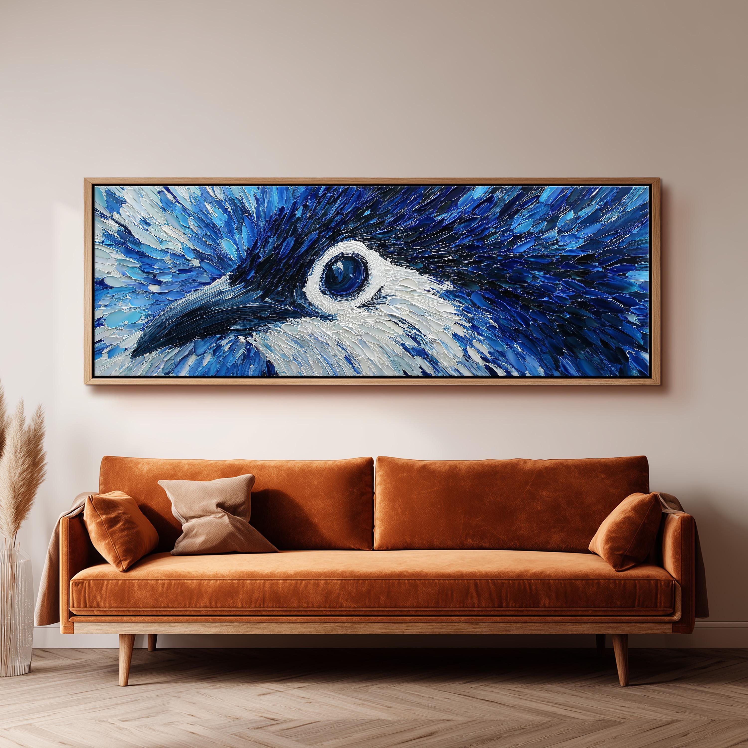 a large, framed painting of a bird's eye on the wall above a brown sofa in a living room setting.