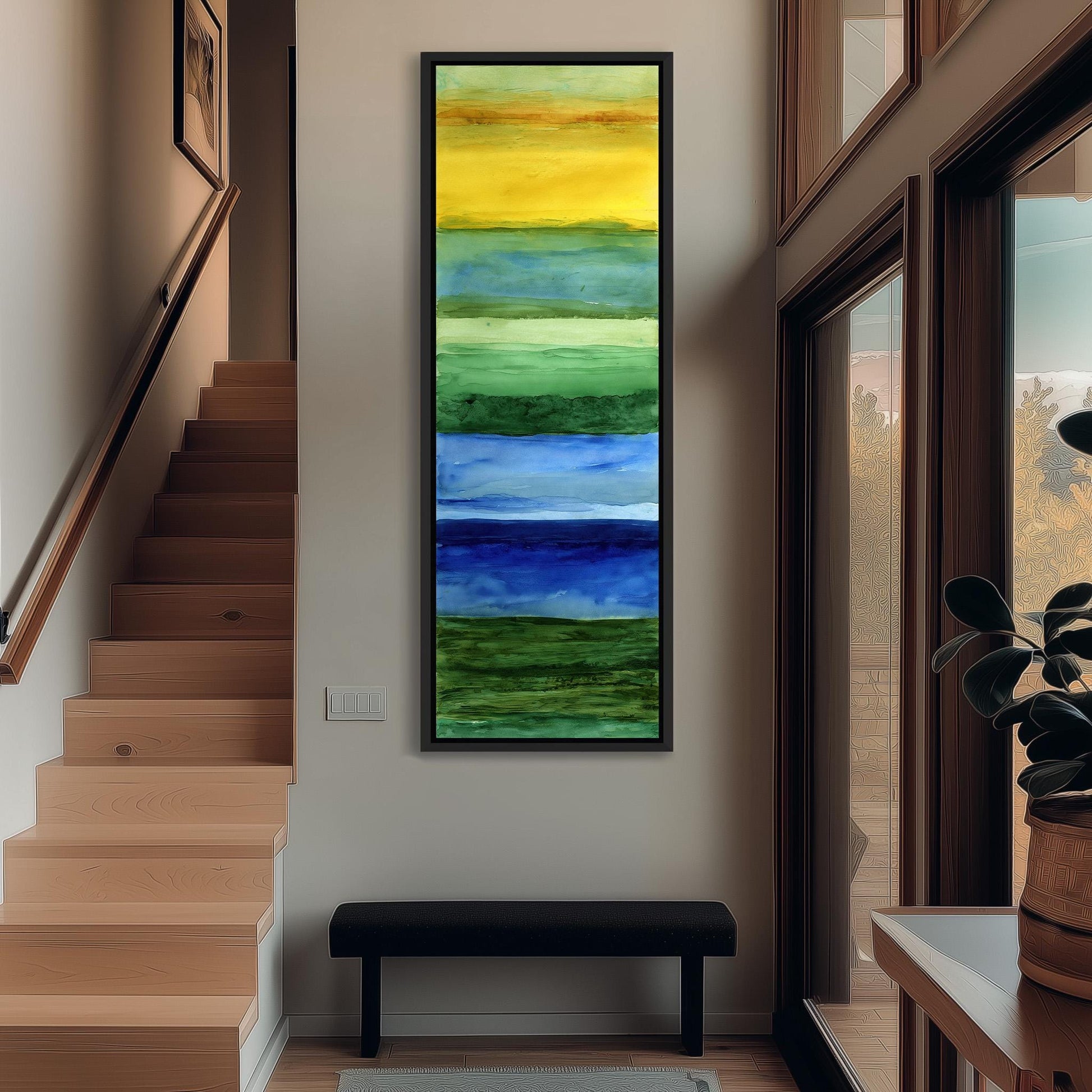 a hallway with a large, colorful painting hanging on the wall. The painting consists of a vertical strip of six panels, each depicting a different color: yellow, green, blue, and purple. The hallway has a wooden staircase leading up to the painting, and there is a bench in the foreground. A potted plant is visible on the right side of the image.