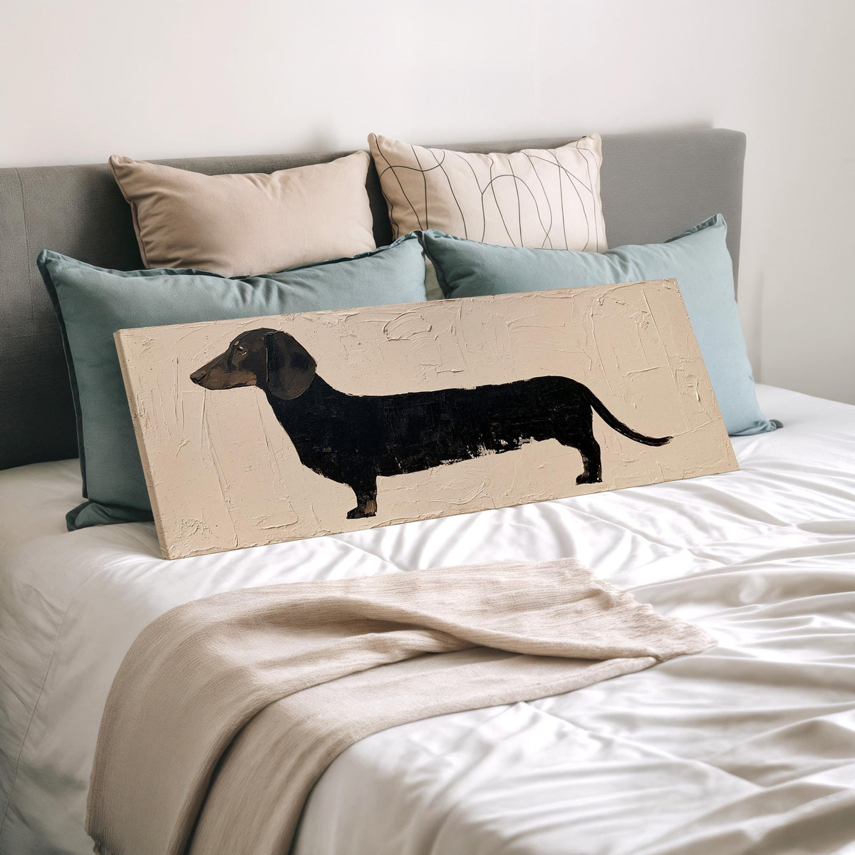 Black dachshund silhouette wide panoramic canvas print laid on a bed to show its size
