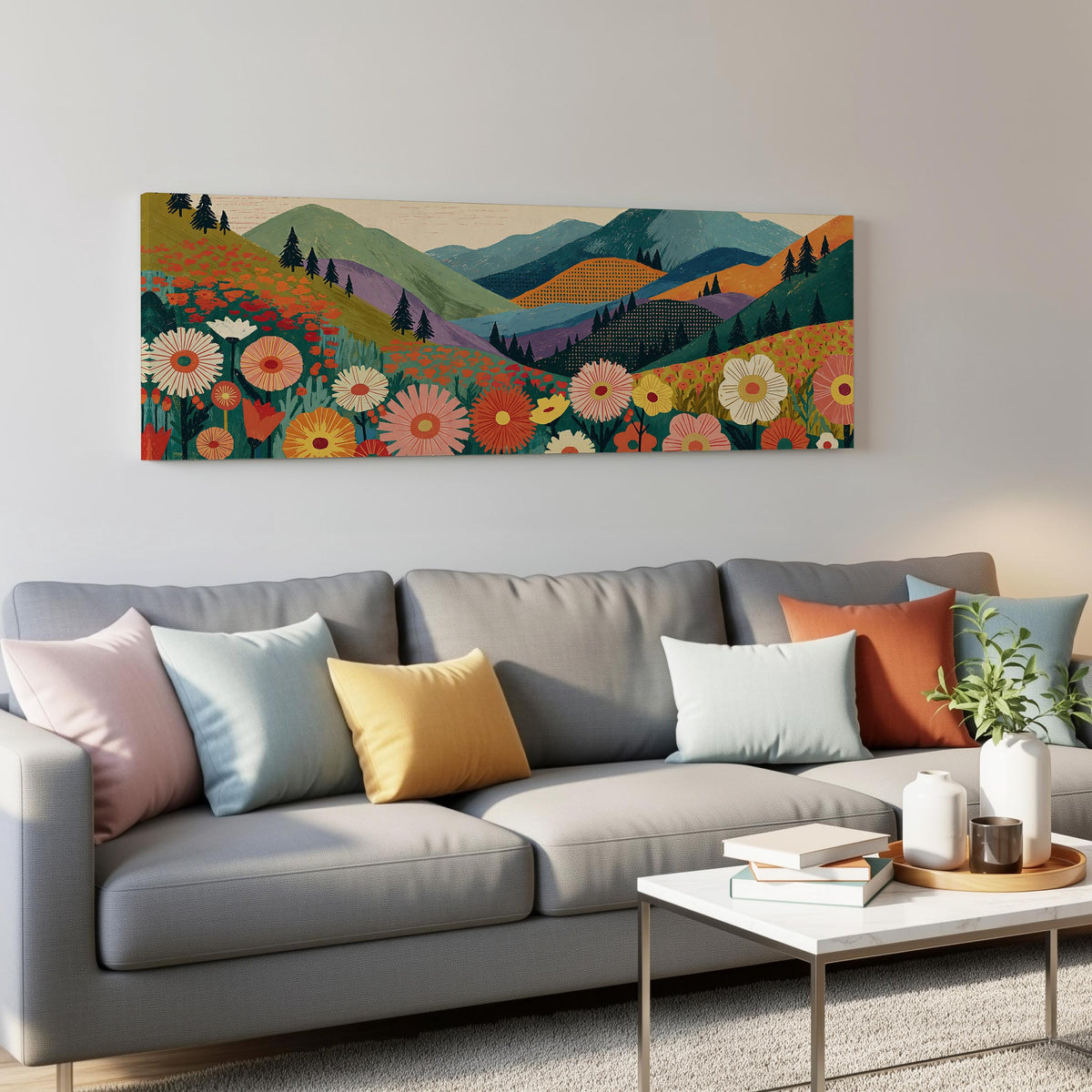 Wildflower valley below patterned mountains panoramic canvas print above a grey sofa in a living room