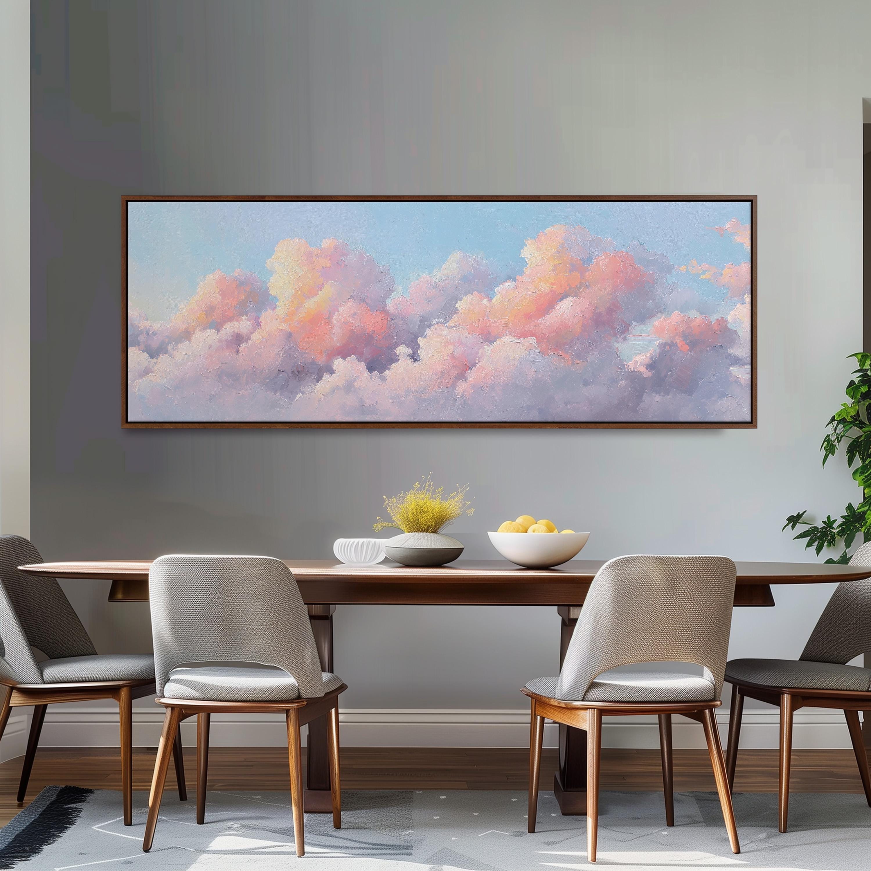 a dining room with a large painting of a cloudy sky hanging on the wall above a wooden dining table with four chairs. The table is set with a bowl of fruit and a vase of flowers, creating a cozy and inviting atmosphere.