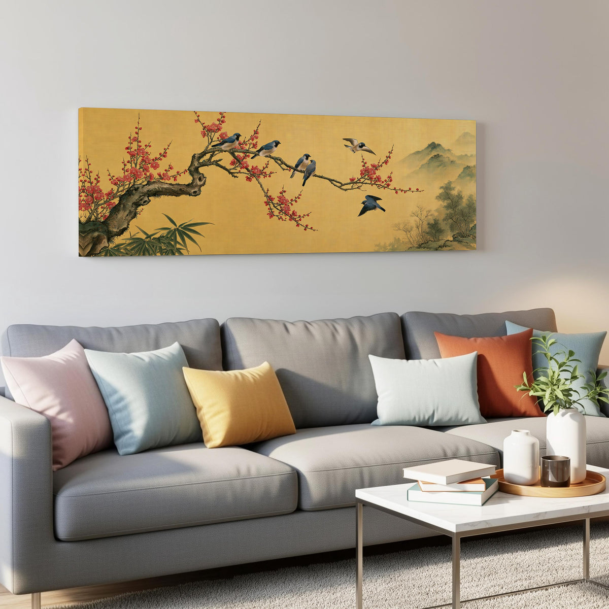 Birds on a plum blossom branch on gold panoramic canvas print above a grey sofa in a living room