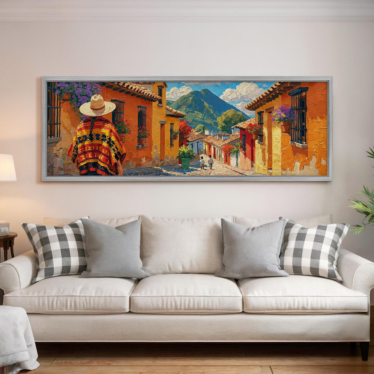 Colorful Guatemalan street with volcano view panoramic canvas print above a white sofa in a bright living room