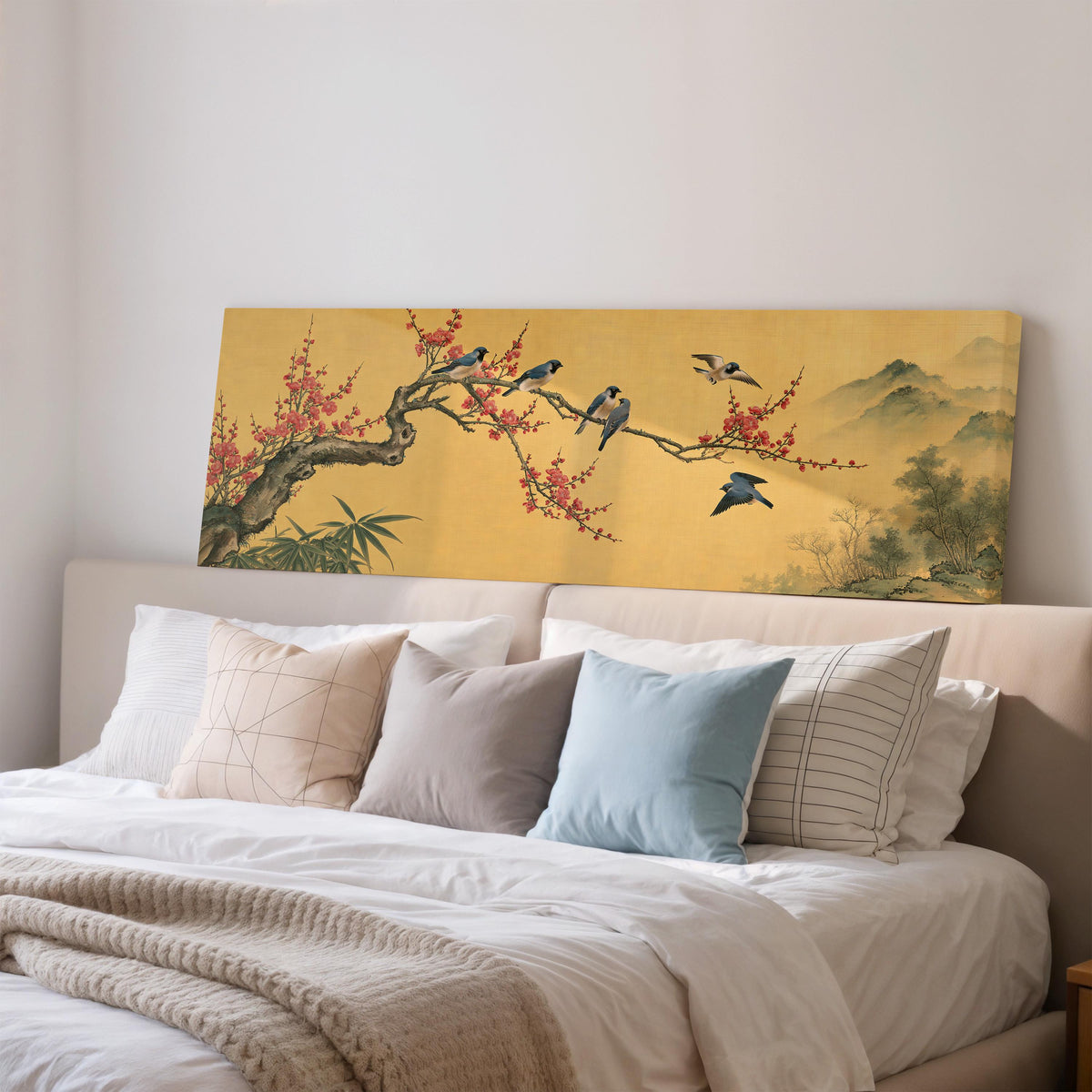 Birds on a plum blossom branch on gold wide panoramic canvas print above a bed in a bedroom