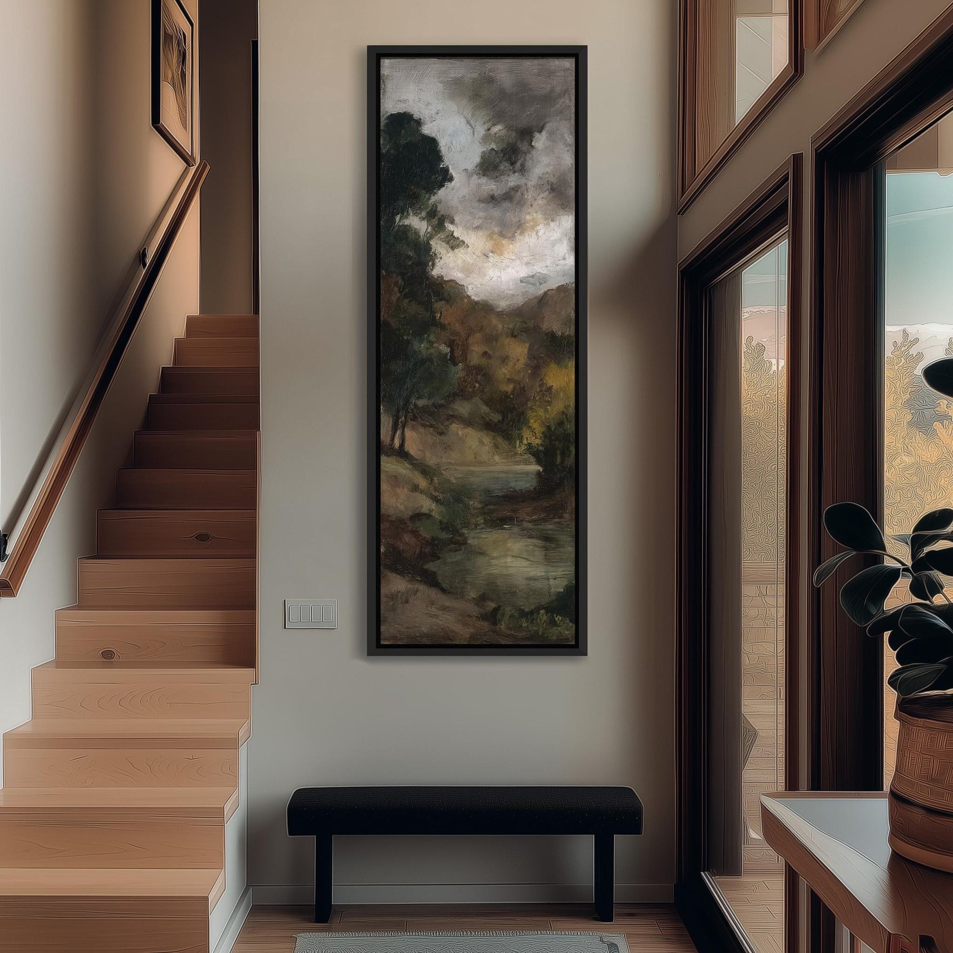 a hallway with a large painting of a landscape hanging on the wall, a wooden staircase, a bench, and a plant in a pot.