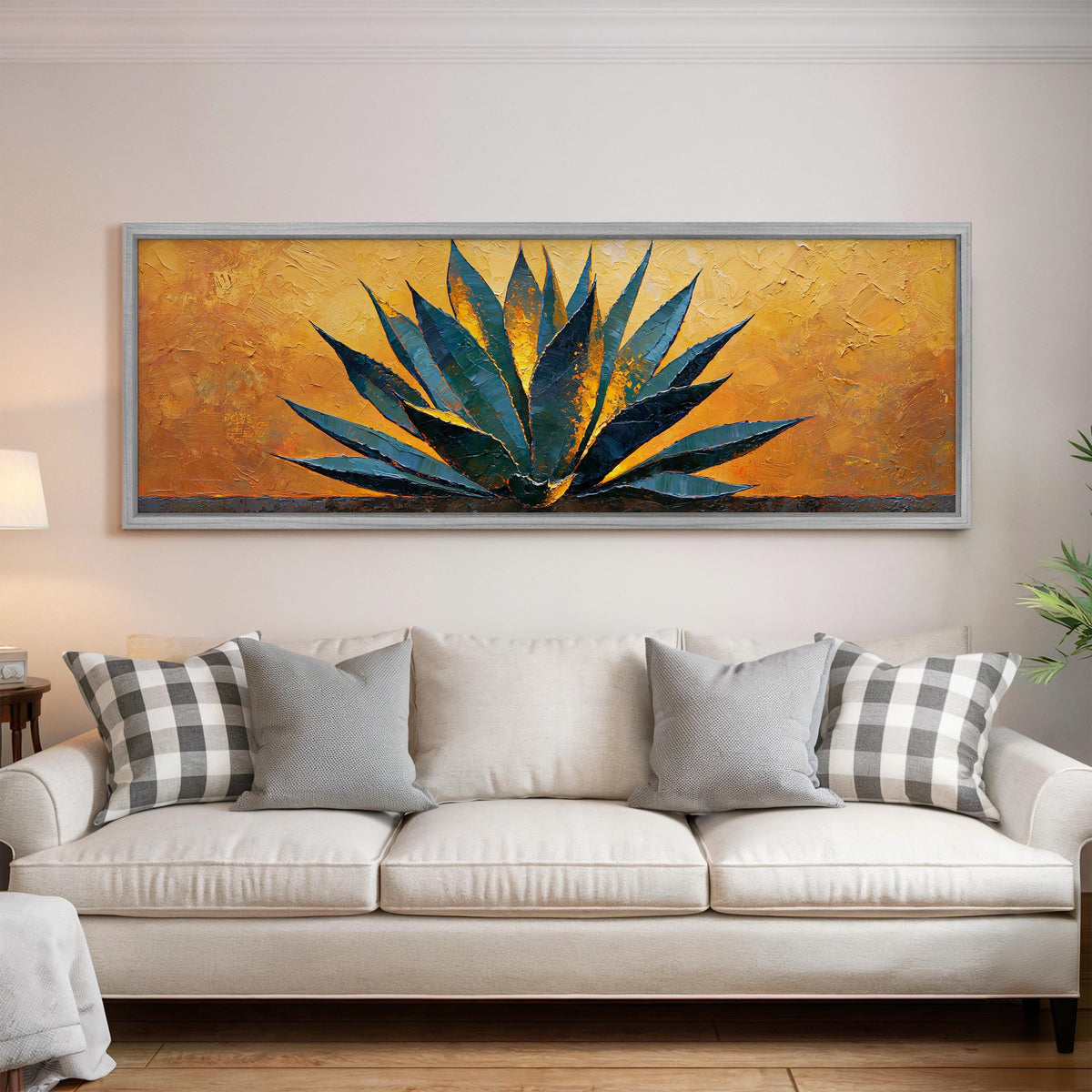 Blue agave on a textured gold background panoramic canvas print above a white sofa in a bright living room