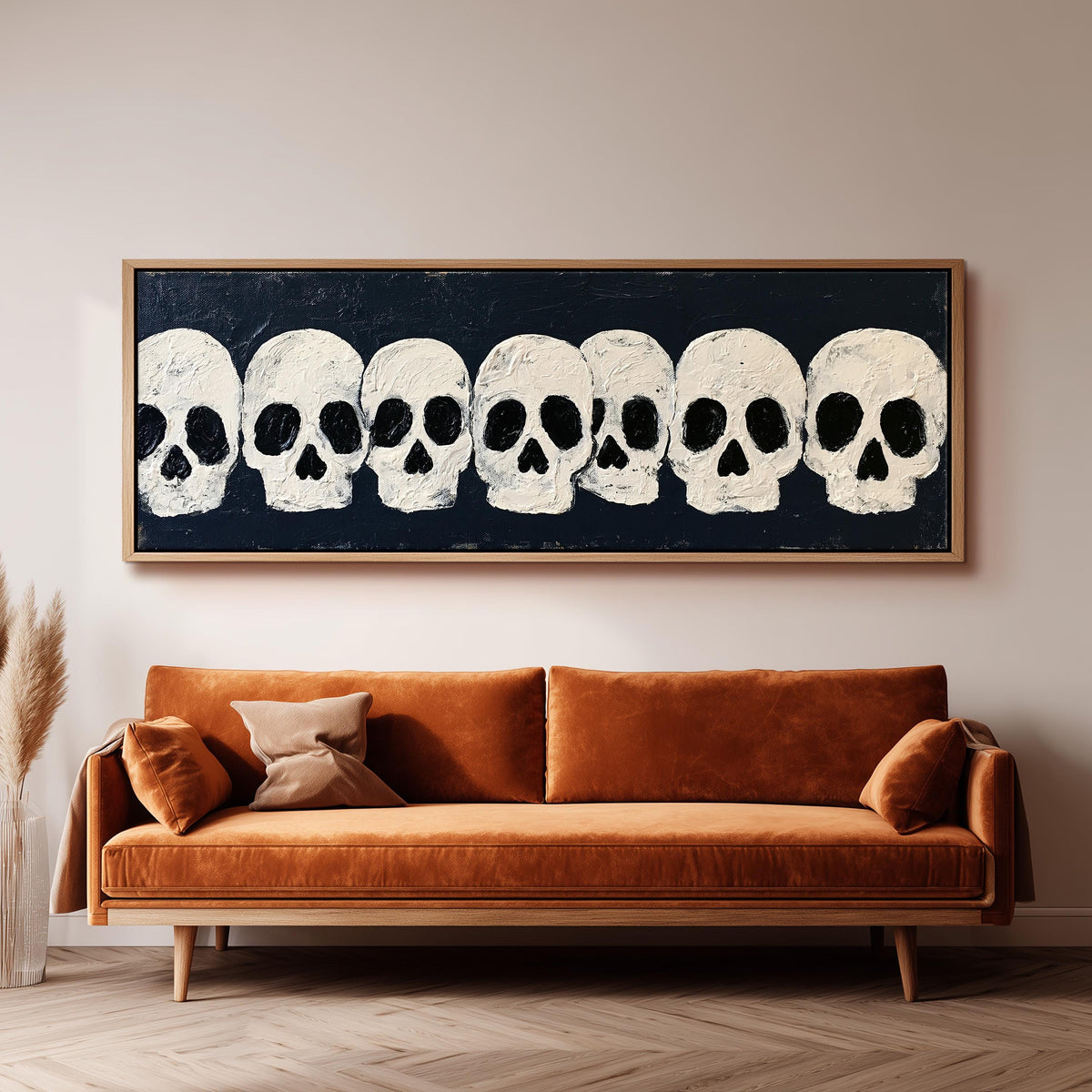 Row of white skulls on navy wide panoramic canvas print above a bench in a dark living room