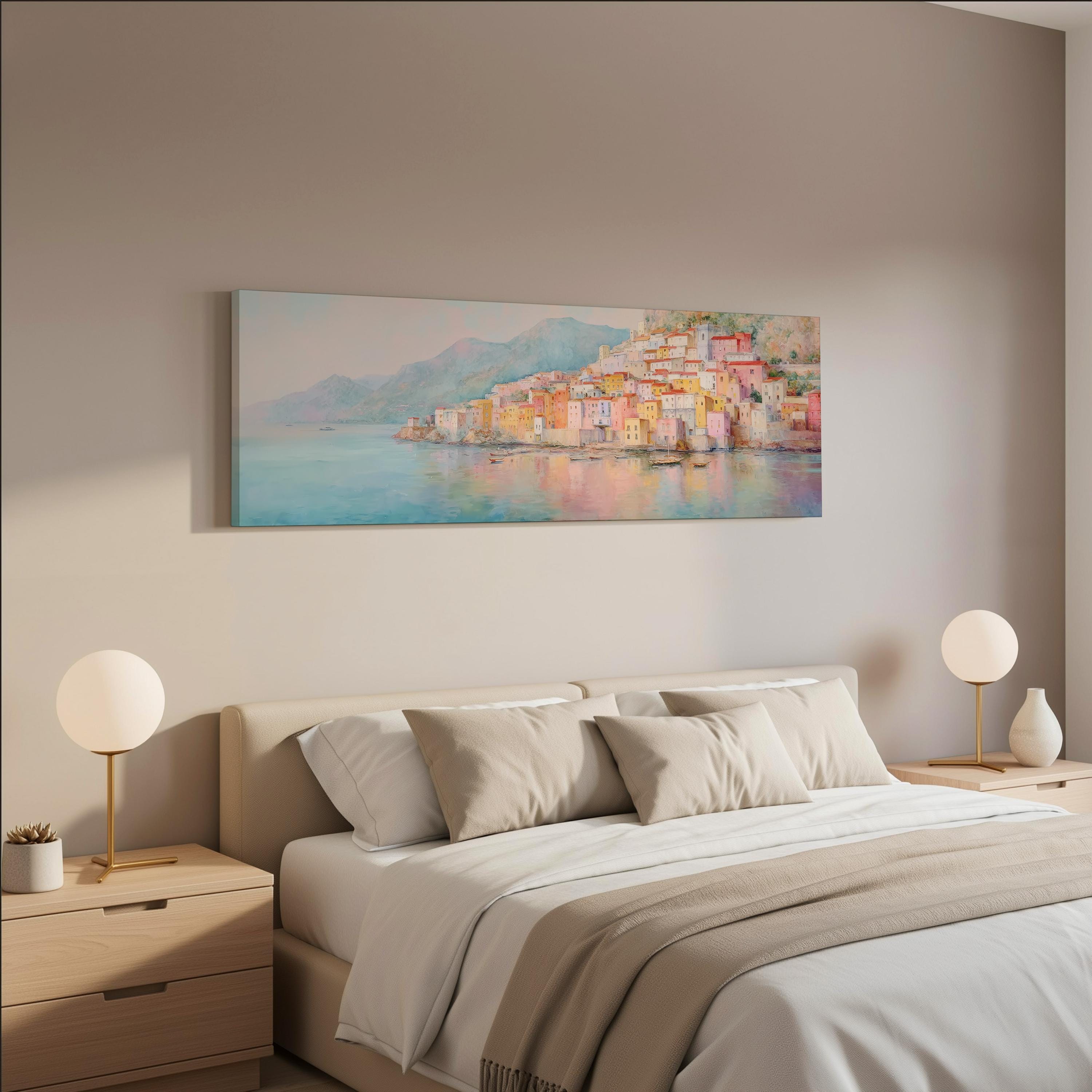 a serene bedroom scene with a large painting of a coastal town hanging on the wall above a bed with white bedding and beige pillows.