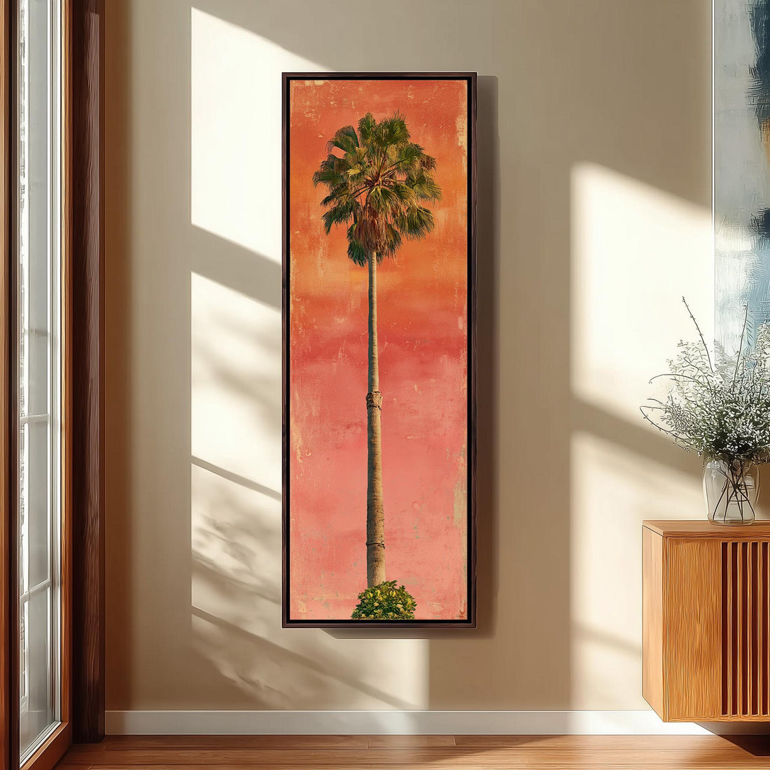 a large, framed painting of a palm tree hanging on a wall in a hallway.