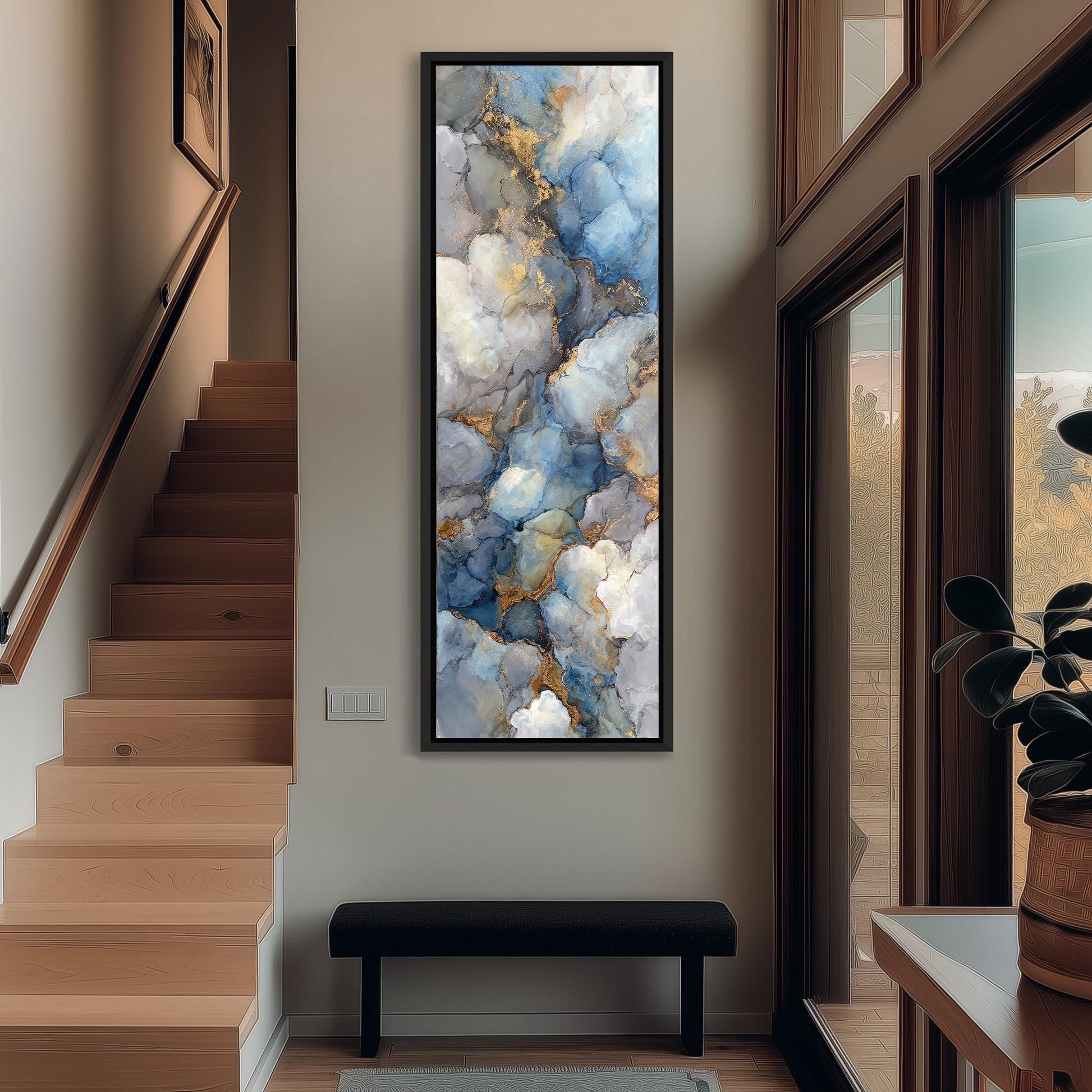 a large abstract painting hanging on the wall of a hallway, with a wooden staircase and a bench in the foreground.