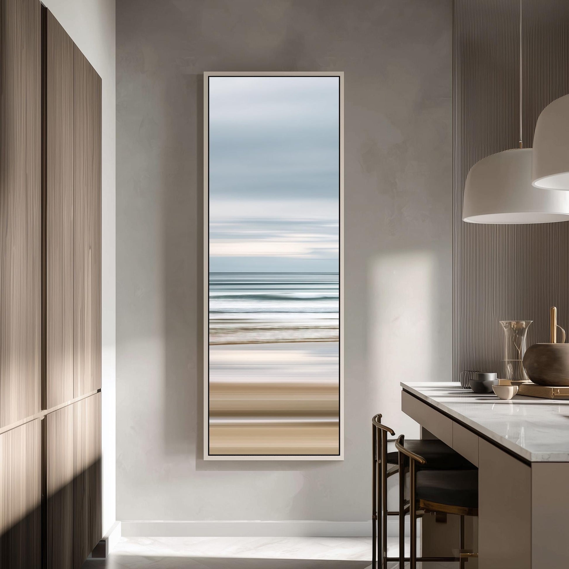 a modern kitchen with a large window that offers a view of the ocean. The window is framed in white and is positioned above a counter with a sink and a stove. The kitchen has a minimalist and clean design, with wooden cabinets and a white countertop.