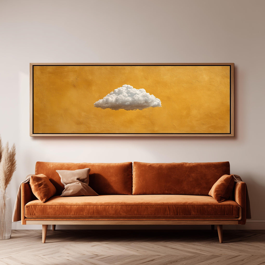 a large, framed painting of a cloud hanging on a wall above a brown sofa.