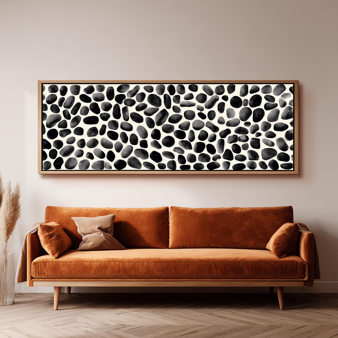 a modern living room with a black and white checkered sofa, a stack of books, and a large abstract painting on the wall.