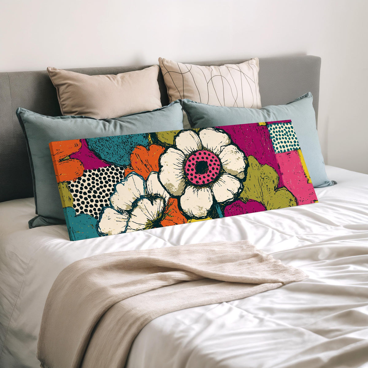 Bold pop blossoms wide panoramic canvas print laid on a bed to show its size