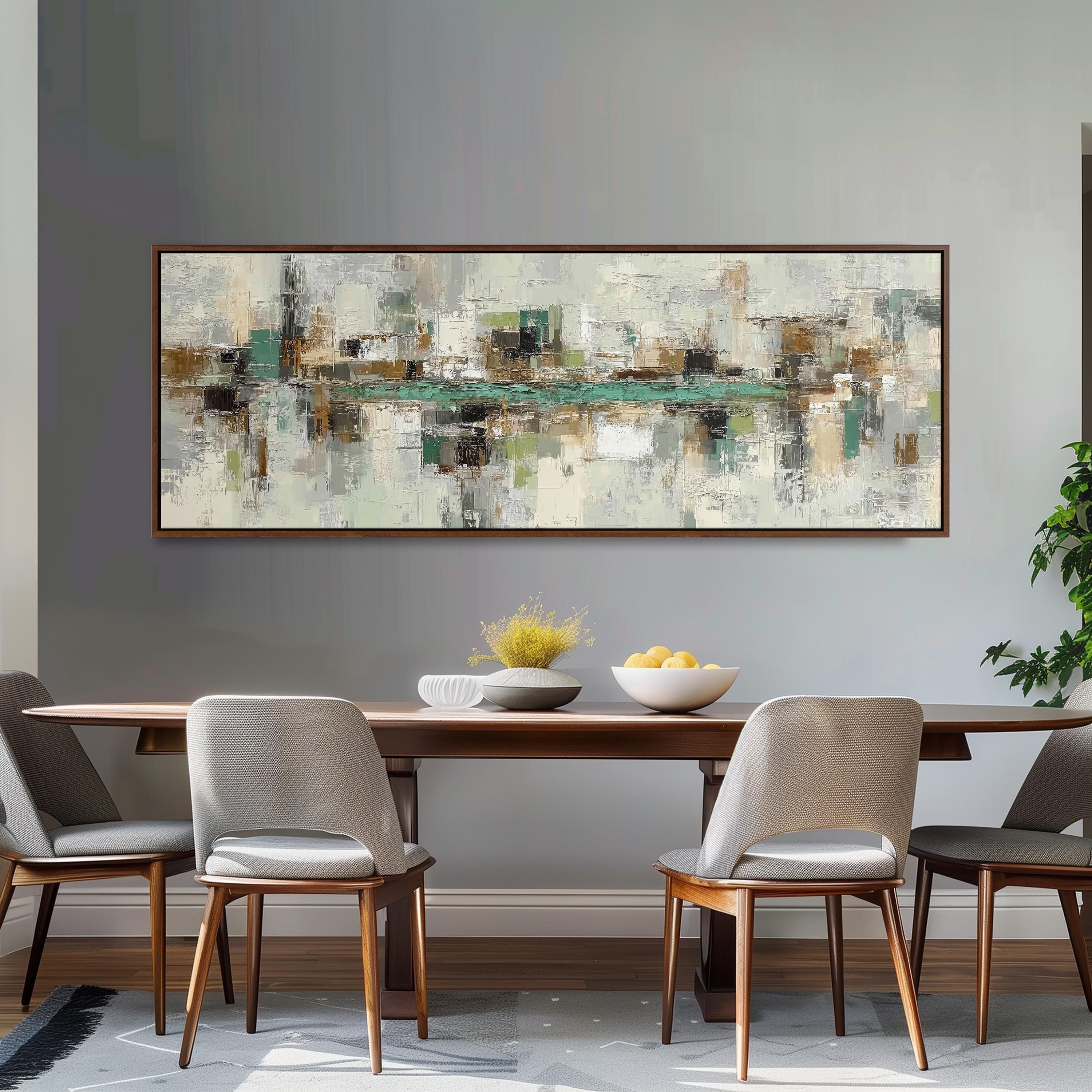 a modern dining room with a large abstract painting hanging on the wall above a wooden dining table with four chairs. The table is set with a bowl of fruit and a vase of flowers, creating a welcoming and stylish atmosphere.