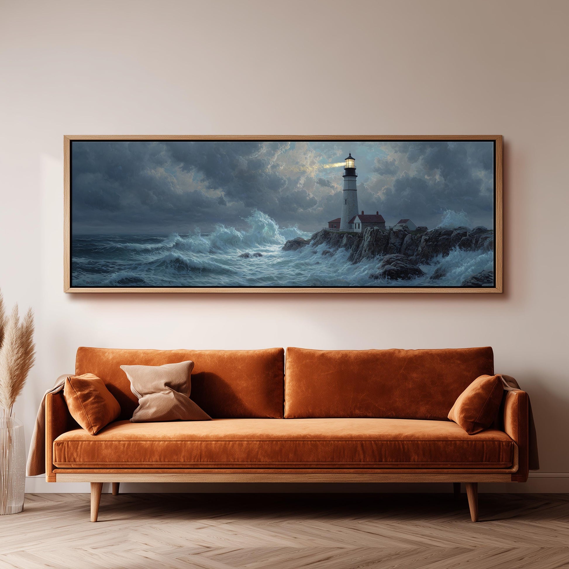 a large painting of a lighthouse on a rocky shore, hanging on a wall above a brown sofa.