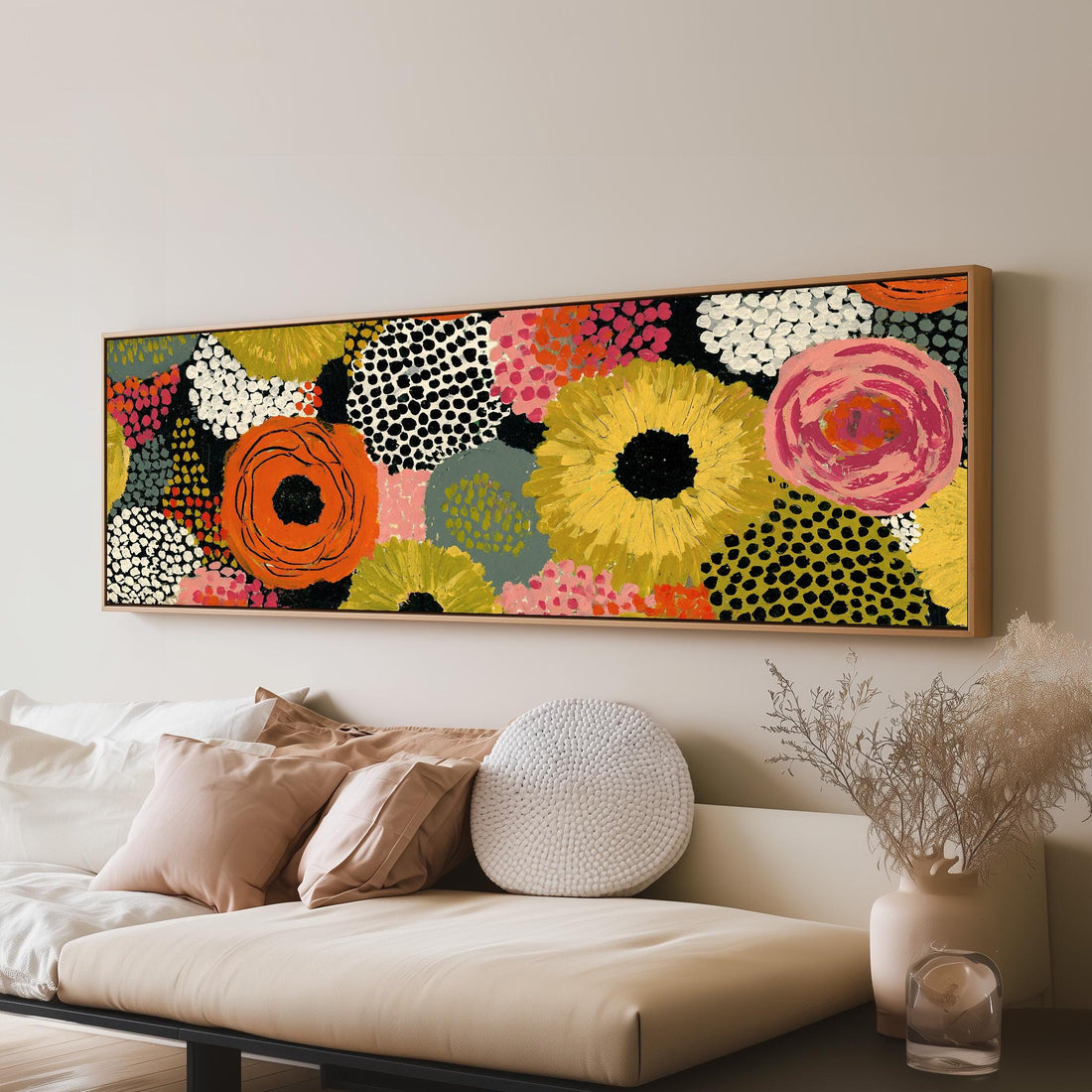 Dotted sunflowers and blooms on black long horizontal canvas print above a sofa in a living room
