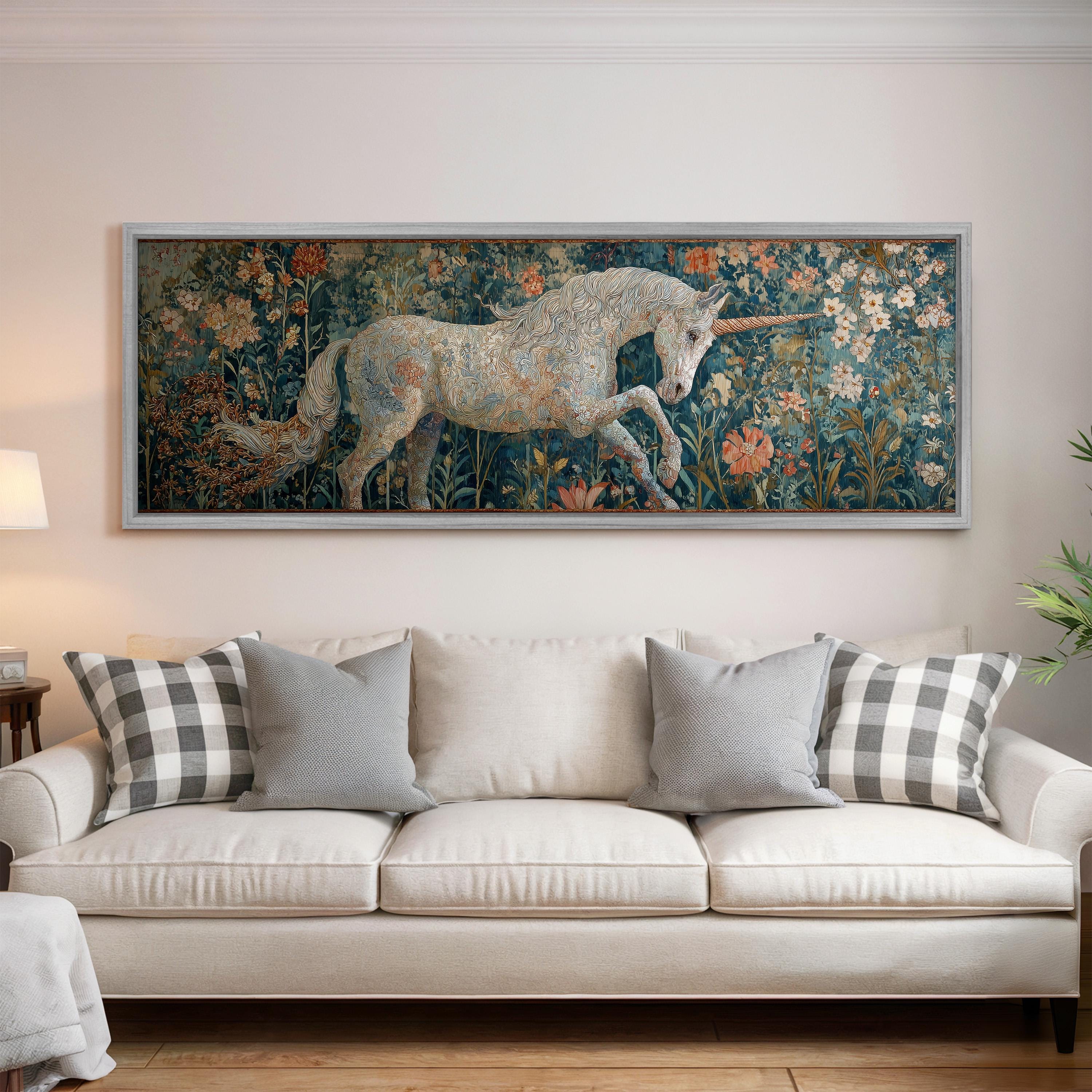 a large painting of a unicorn on a wall above a white couch with decorative pillows.