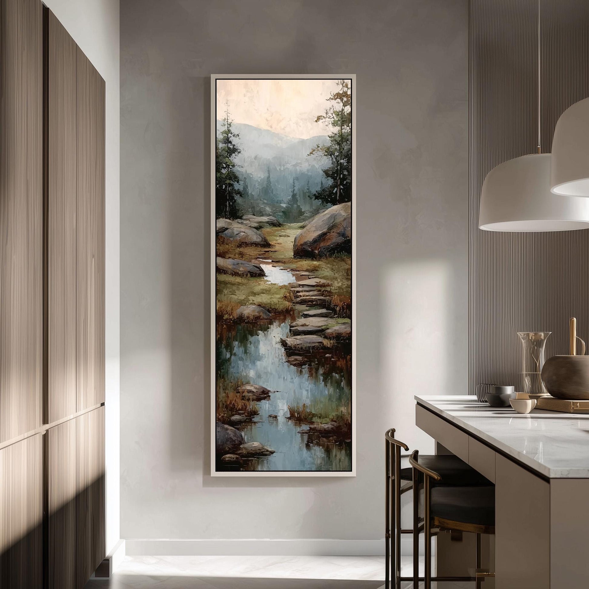 a large painting of a serene landscape with a stream, surrounded by trees and mountains. The painting is hung on a wall in a modern kitchen, creating a harmonious blend of art and design.