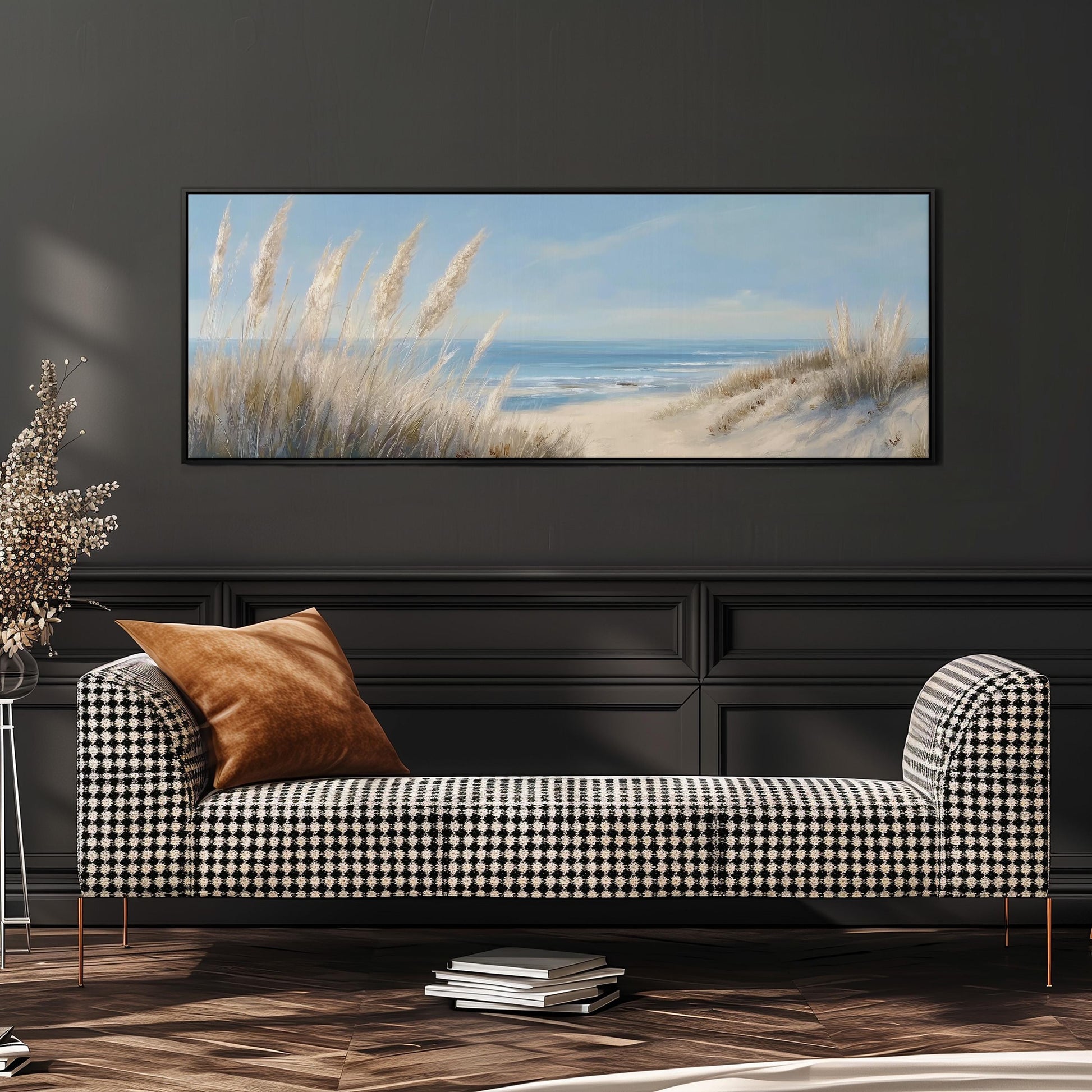 a large painting of a beach scene hanging on a wall above a black and white checkered sofa with a brown throw pillow.