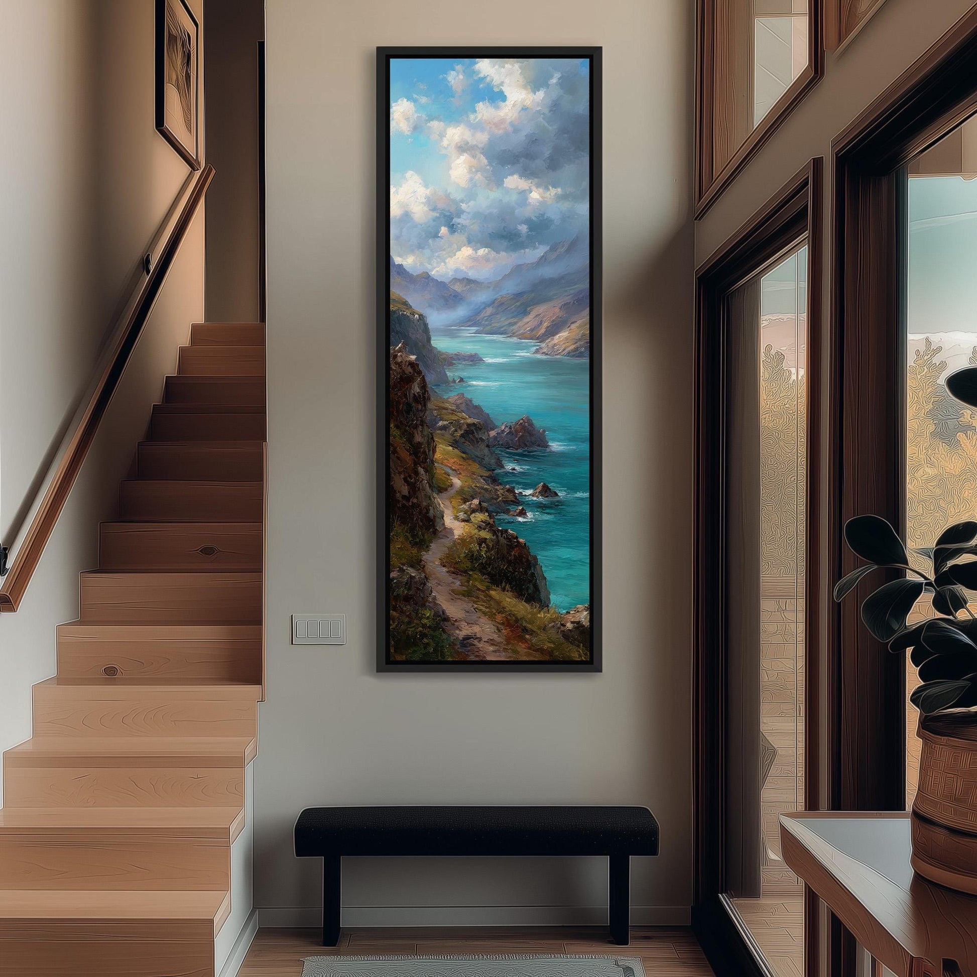 a large painting of a scenic coastal landscape hanging on the wall of a room with wooden stairs and a bench.
