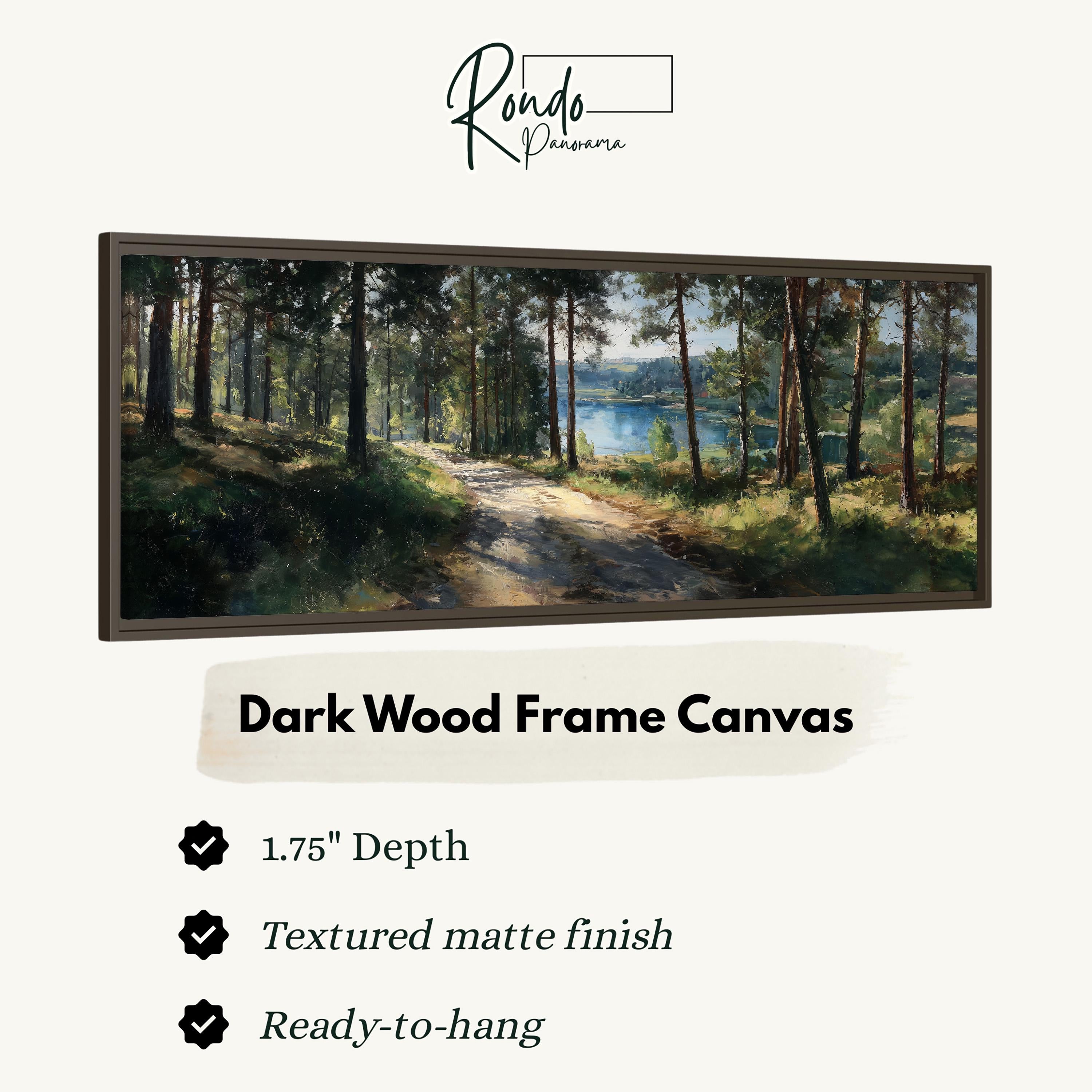 The image is a painting of a forest with a lake in the background, displayed in a dark wood frame.