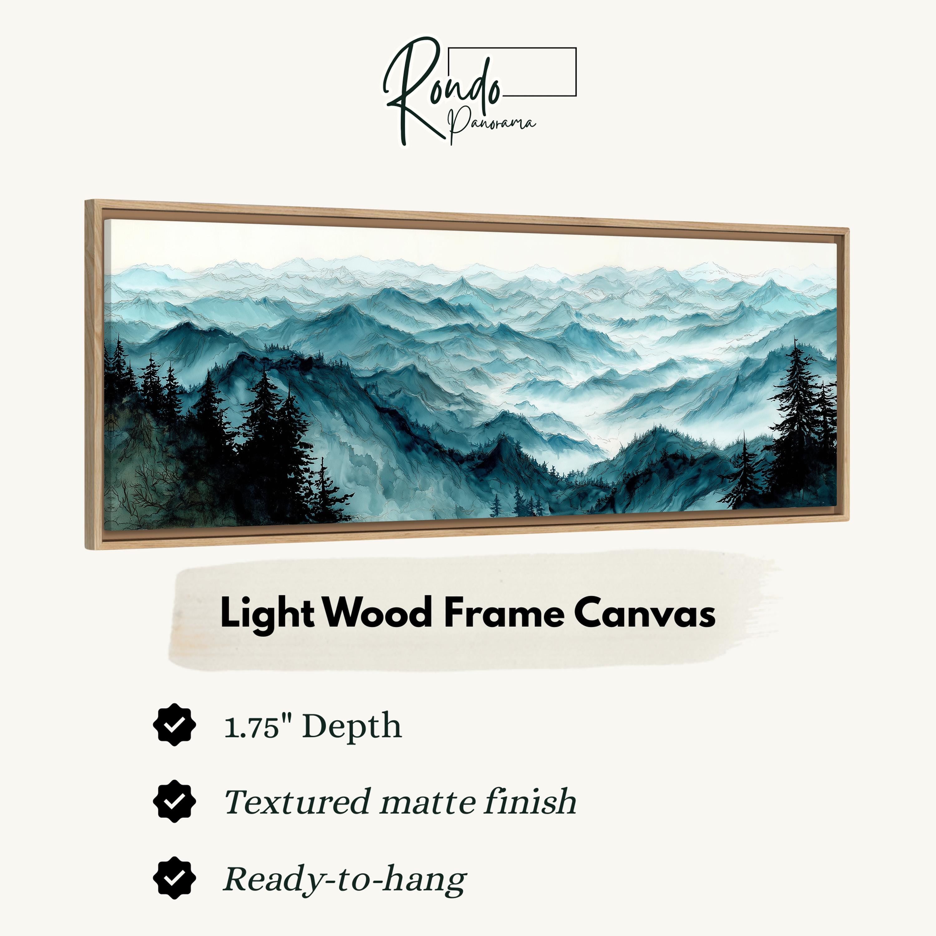 The image is a framed artwork depicting a serene mountain landscape with pine trees and misty peaks.