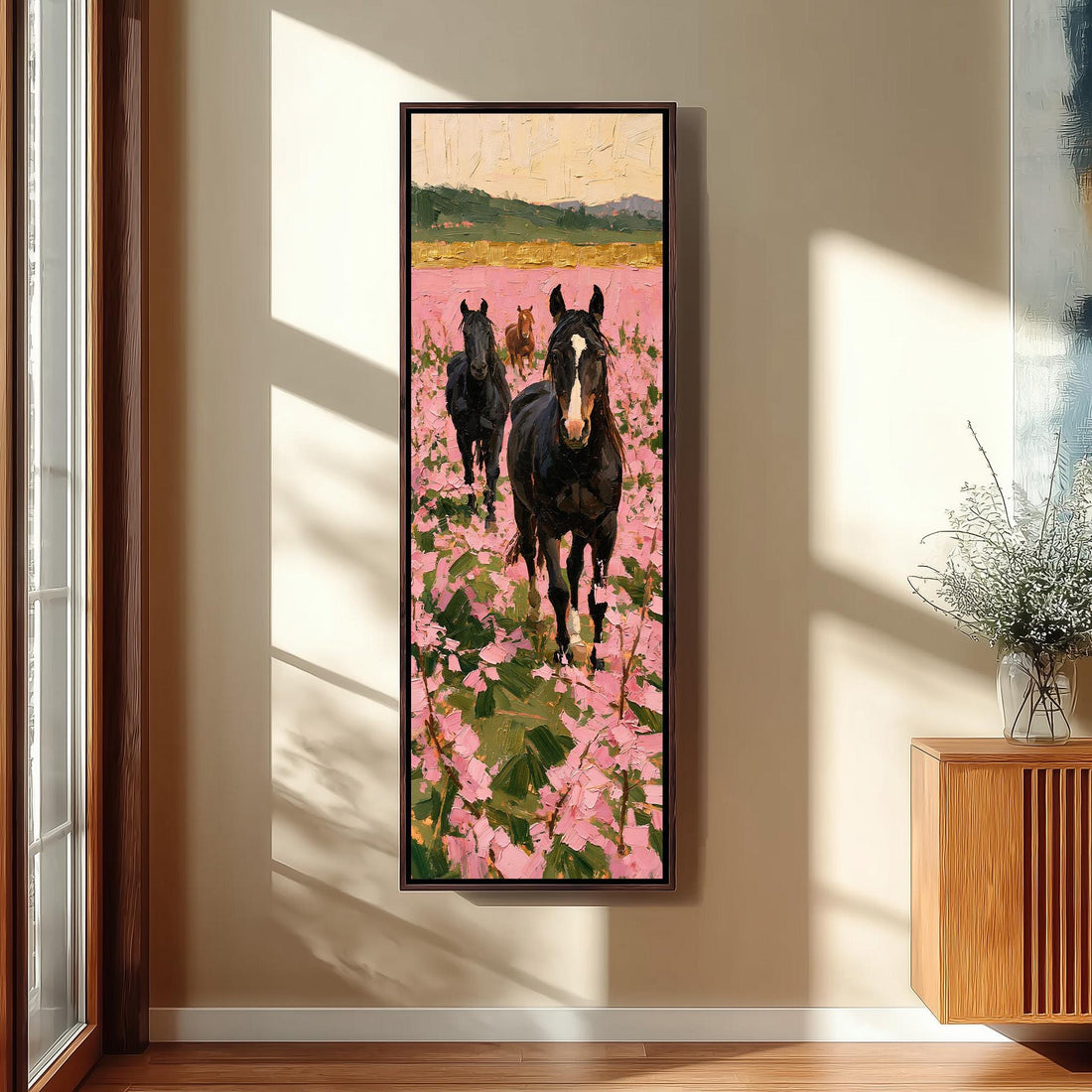 Wild horses walking through a pink wildflower meadow long vertical canvas print in a sunlit living space