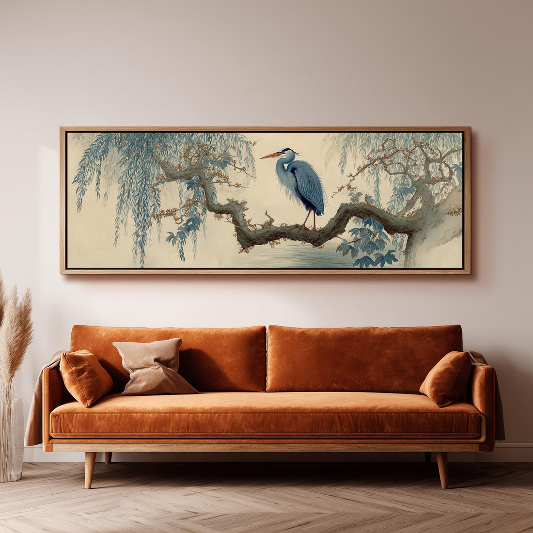 a dining room with a large painting of a blue heron perched on a branch above a wooden table. The table is set with a bowl of fruit and a vase of flowers. The room has gray walls and a gray carpet, creating a calm and elegant atmosphere.