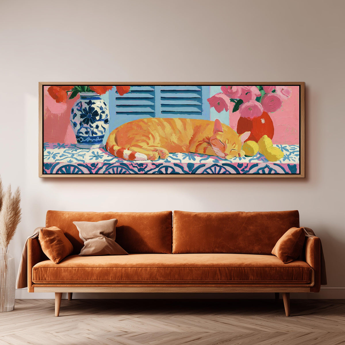 Orange cat napping on a tiled table long horizontal canvas print above a sofa in a living room