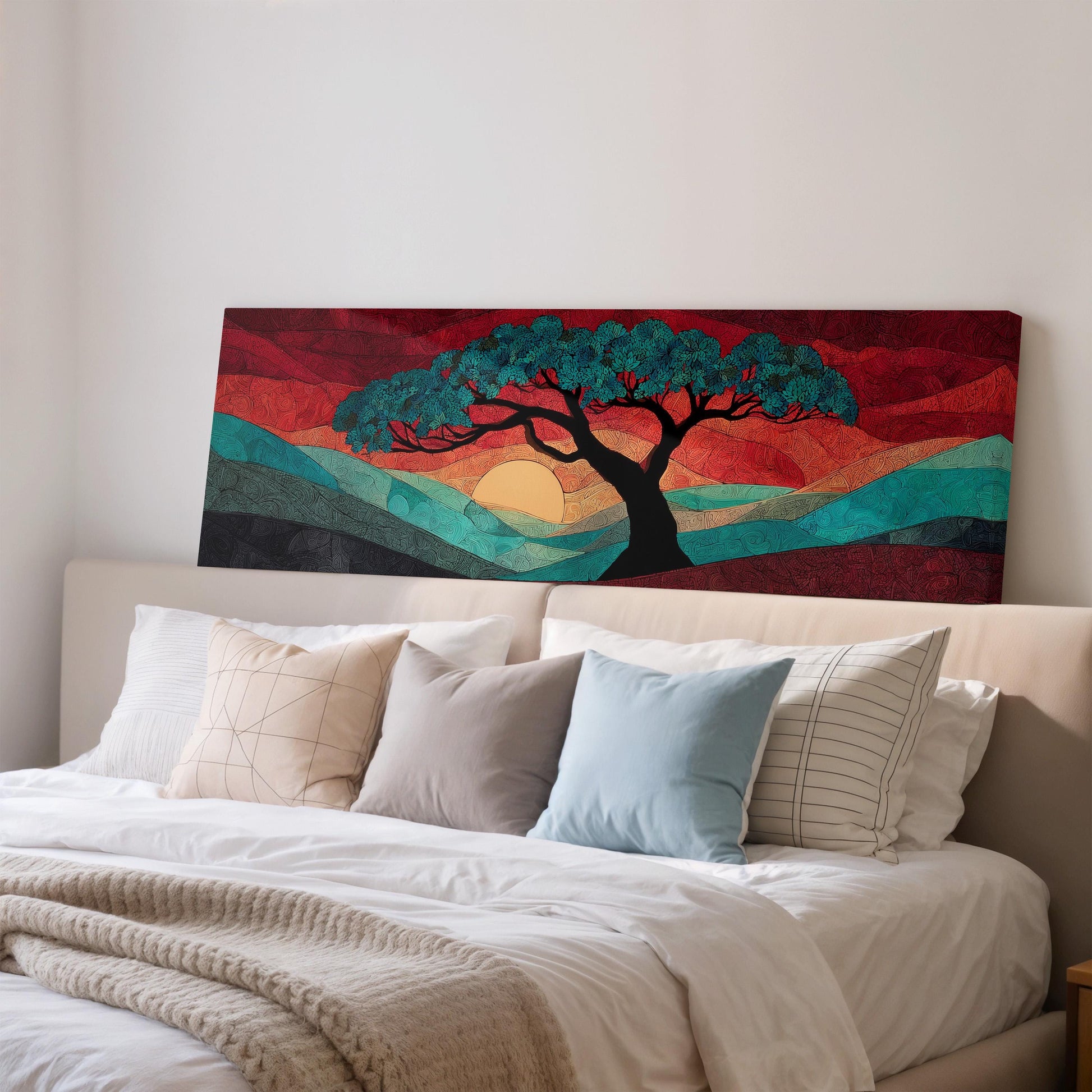 a large, colorful painting of a tree with a sunset in the background, hanging on a wall above a bed with white pillows and a gray blanket.