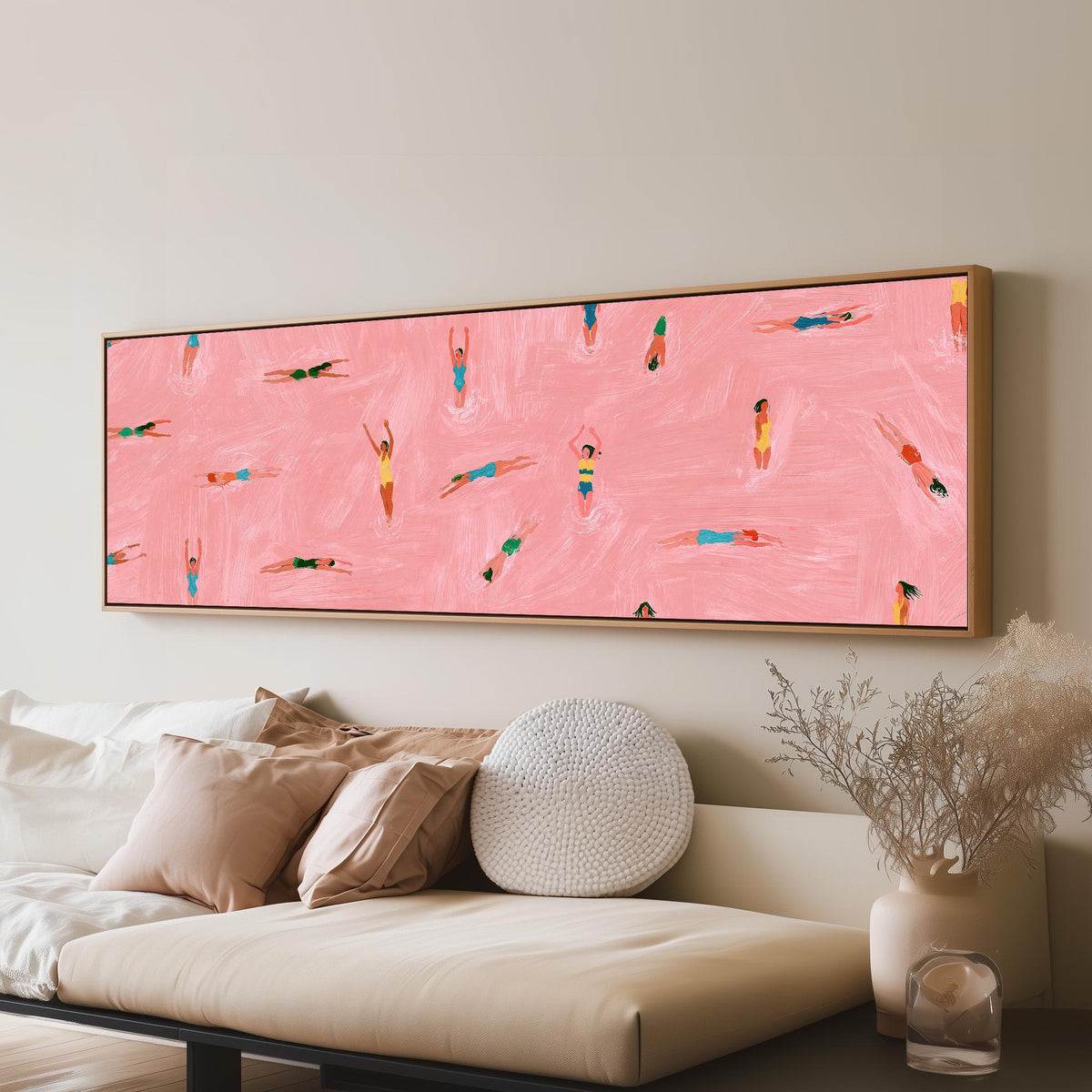 Tiny swimmers in a pink pool from above panoramic canvas print above a sofa in a living room