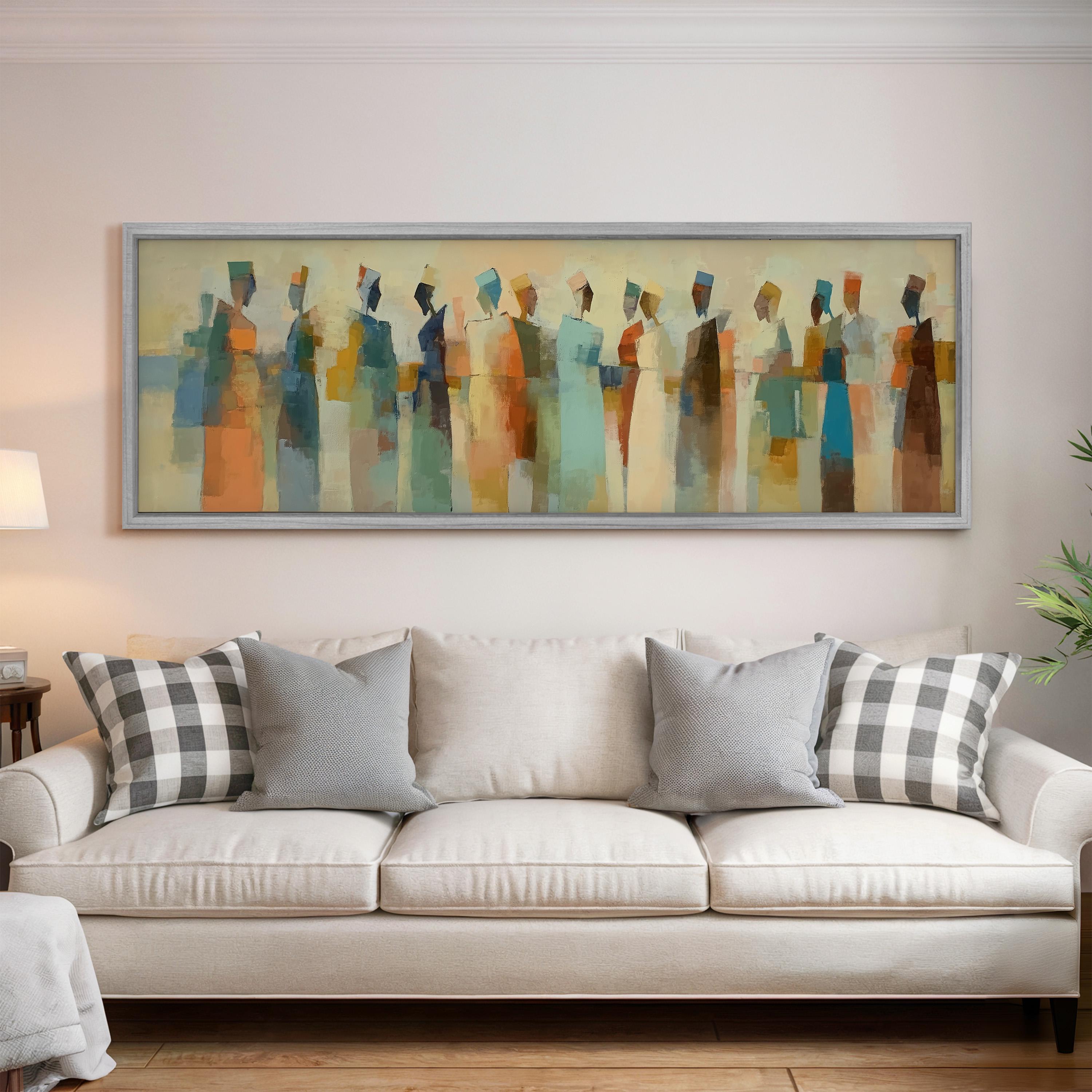 a large, colorful abstract painting hanging on a wall above a white couch with gray and white plaid throw pillows.