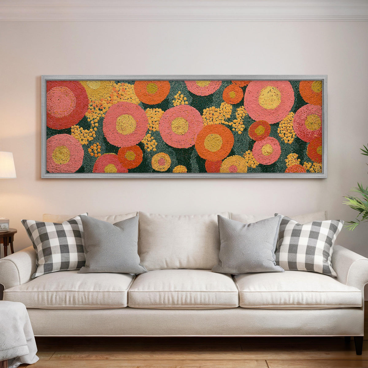Pink circle blooms panoramic canvas print above a white sofa in a bright living room