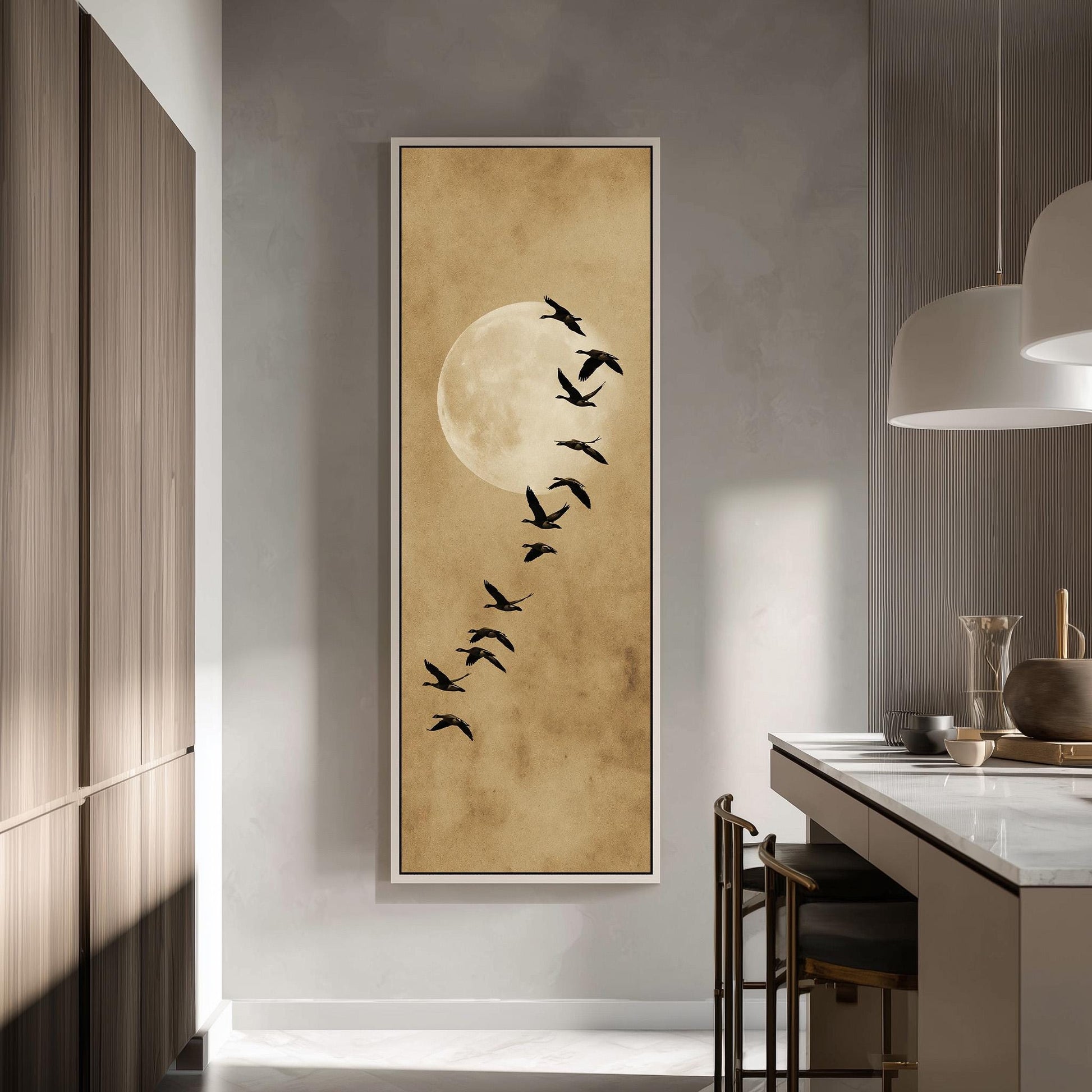 a large framed artwork depicting a flock of birds flying in the sky, with a large moon in the background.