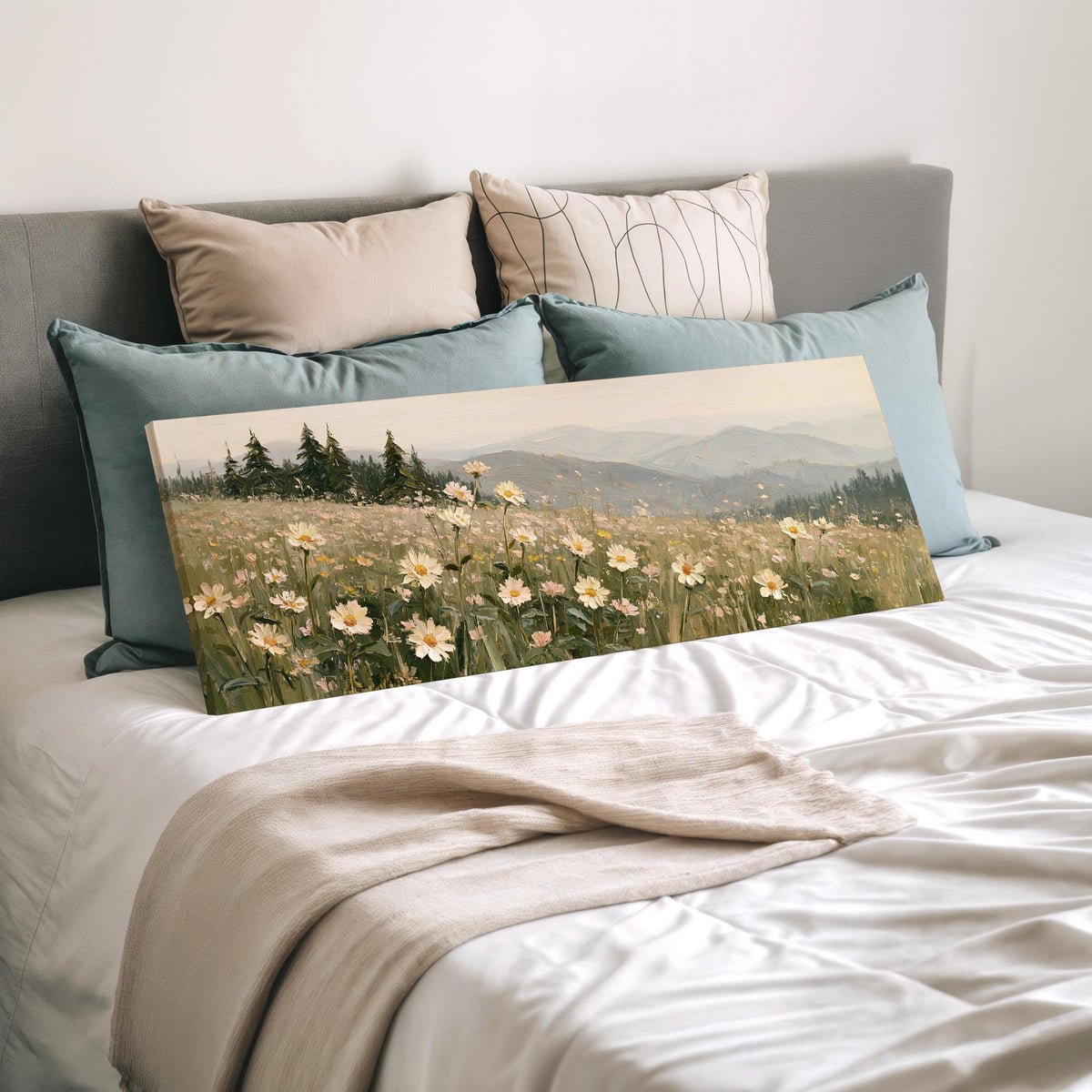 Daisy hillside below blue mountains wide panoramic canvas print laid on a bed to show its size