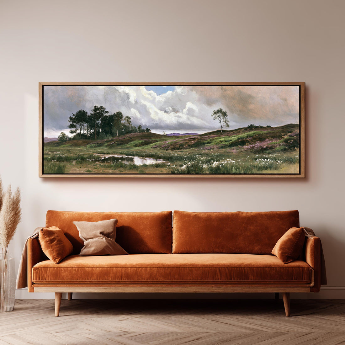 Windswept countryside heath under big clouds long horizontal canvas print above a sofa in a living room