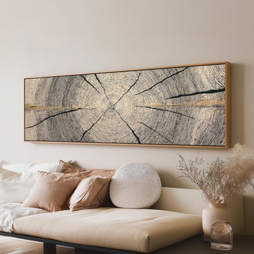 Pale gold wood ring long horizontal canvas print above a sofa in a living room